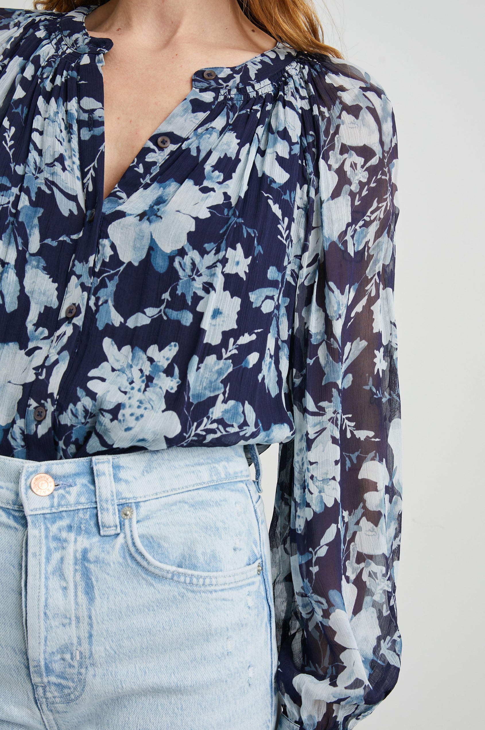 Nessie Long Sleeve Top with Front Button Closure and Ruching along the Neckline in Indigo Blossoms Colorway, Flowers in Blue on Indigo - Front Tucked View Featured on Model