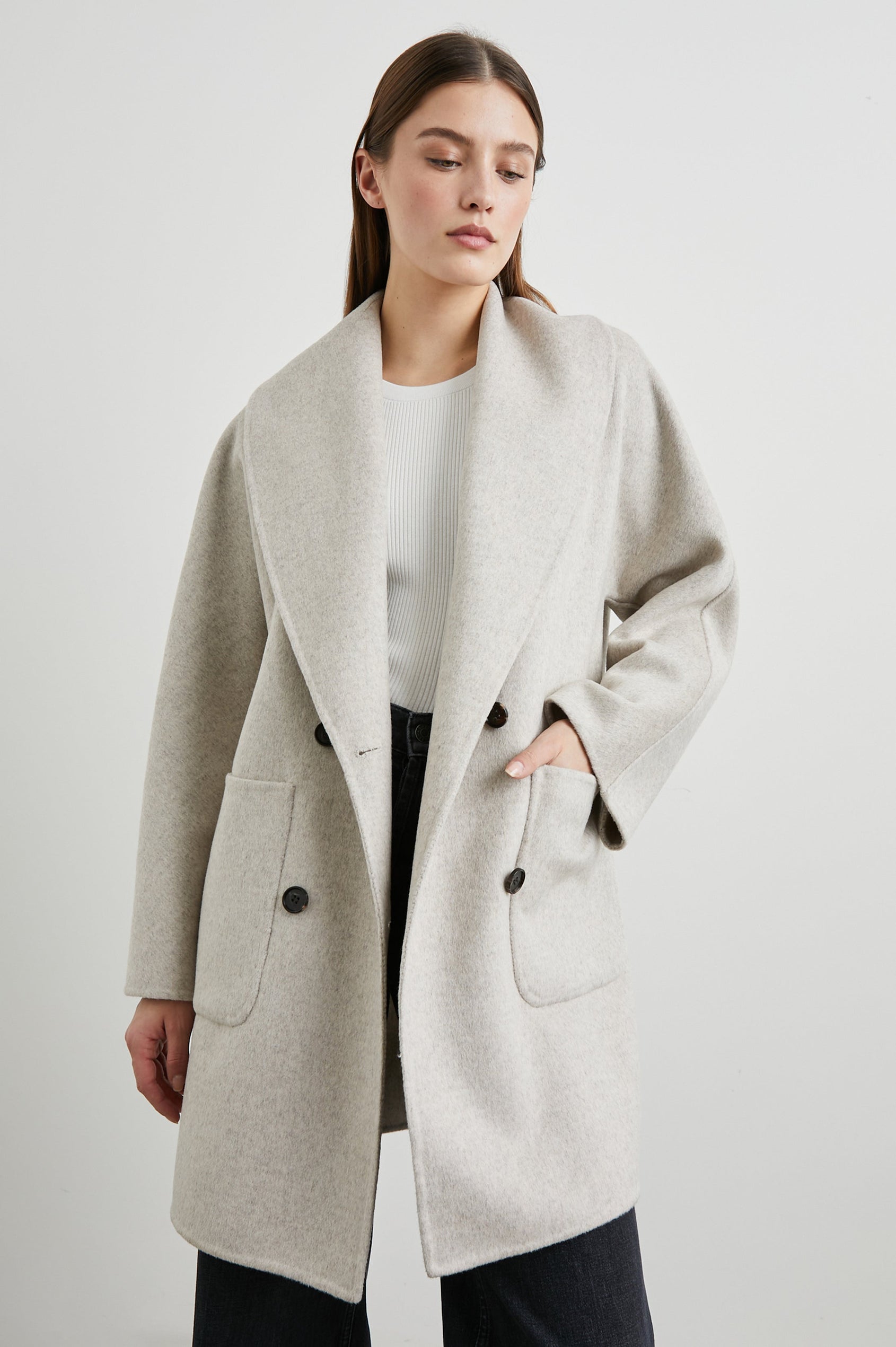 Nily Mid-Thigh Length, Double-Breasted Coat with Two Button Closure, Two Front Patch Pockets and a Shaw Collar in Oatmeal Colorway - Front View Featured on Model