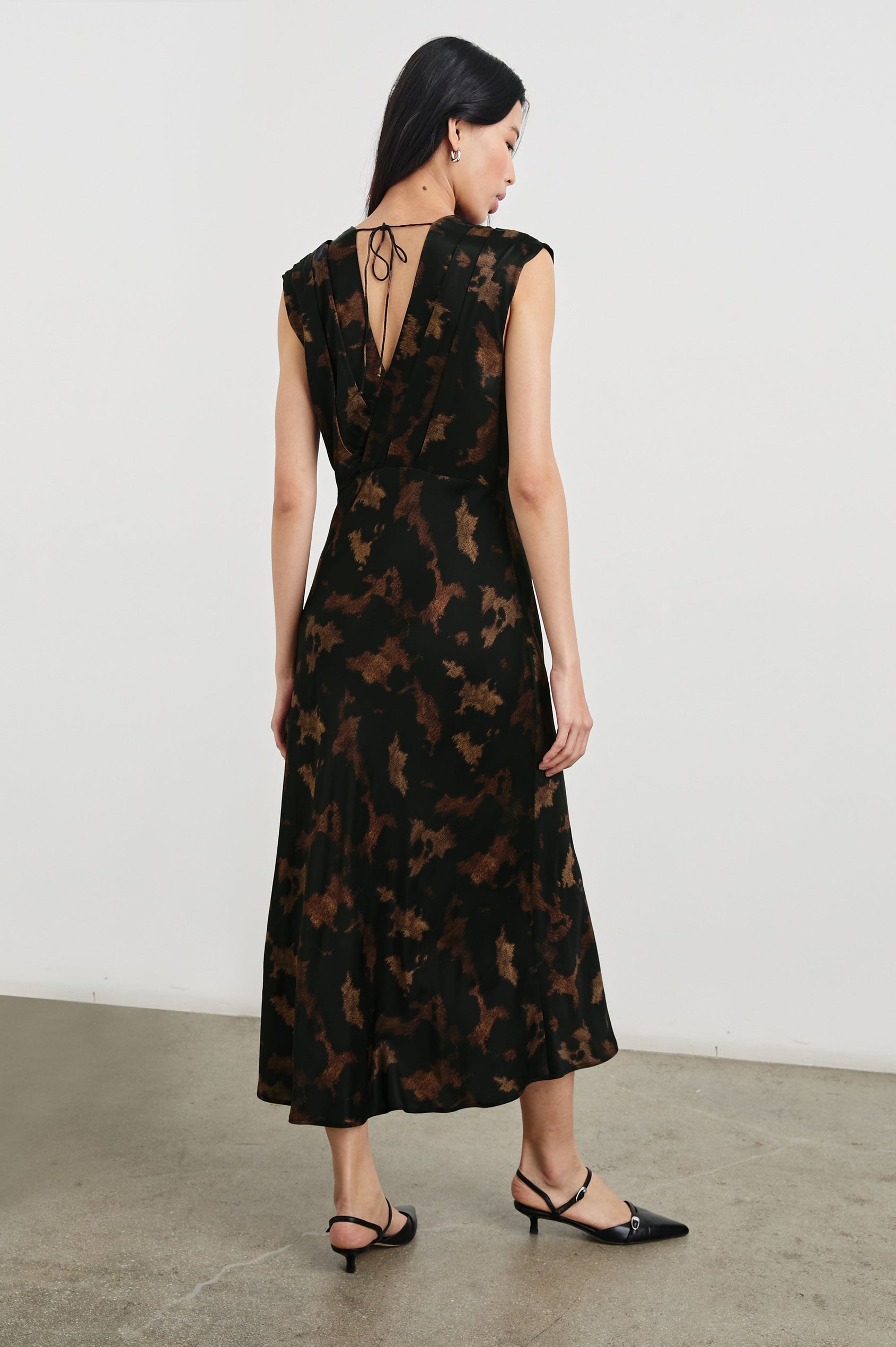 Odella Midi Dress with Cap Sleeves, Double Front Crossover Bodice, Deep V Neck and a Back Neck Tie in Diffused Sandstone Colorway, a pattern in Browns and black - Back Full Body View Featured on Model