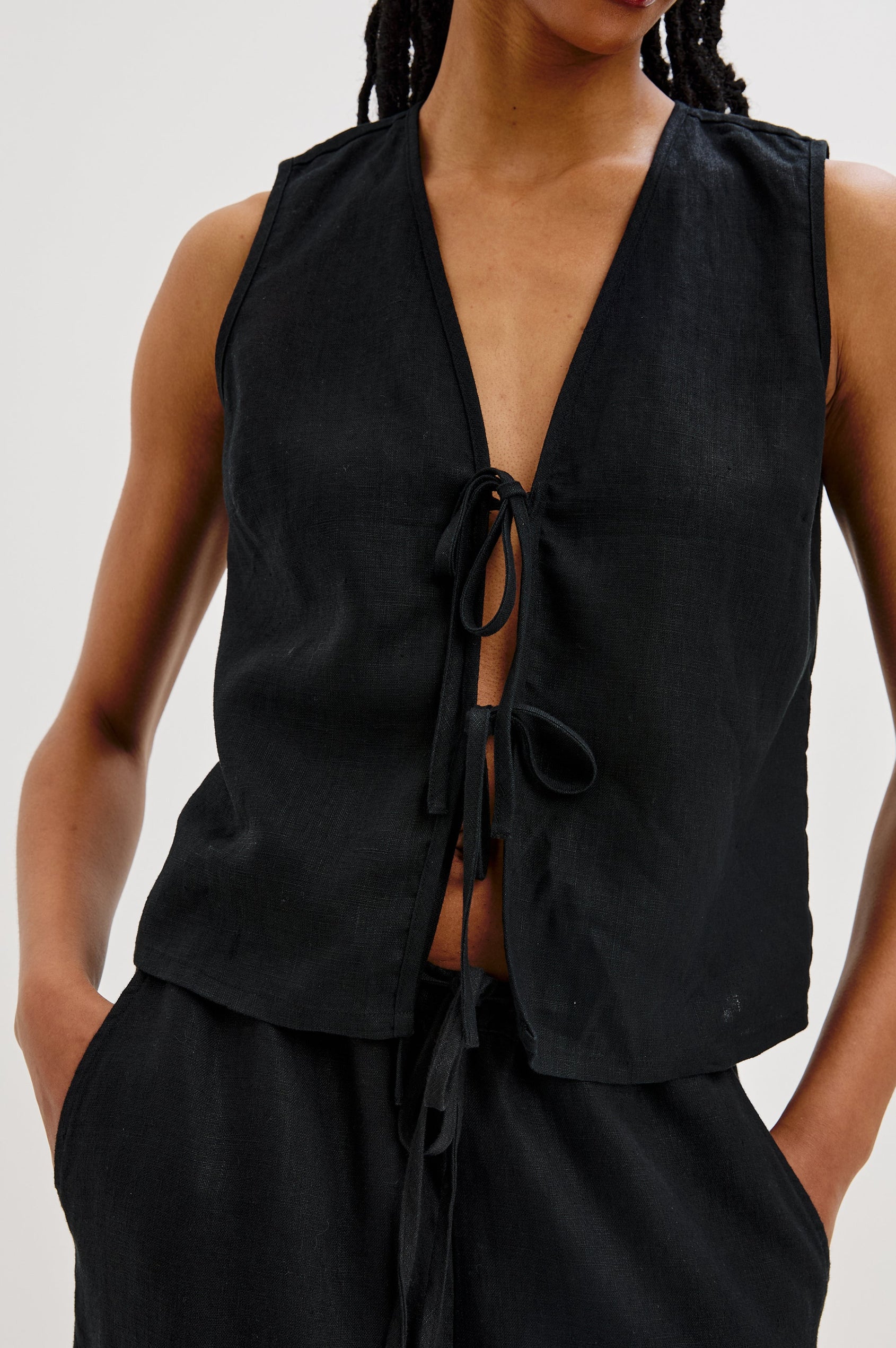 Oregon Sleeveless Vest Top with Tie Front in Black Colorway. Front Detailed View Shown on Model.