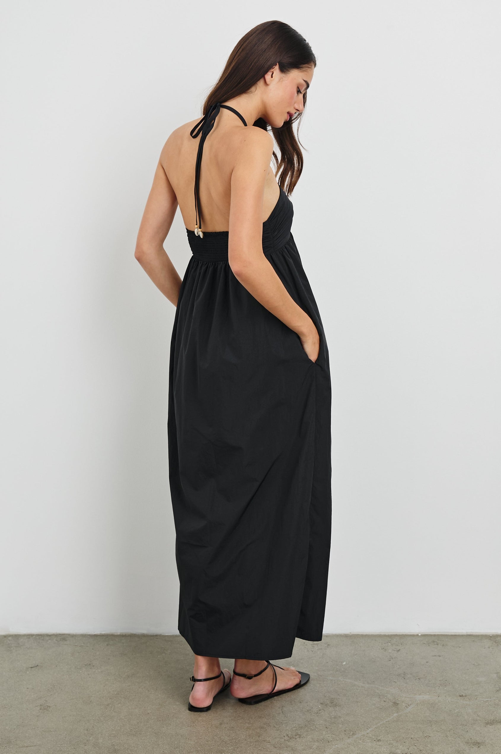 Palazzo Halter Midi Length Dress with Tie Neck and Sea Shell Lattice Detail at Center Front in Black Colorway. Full Body Back View Shown on Model.