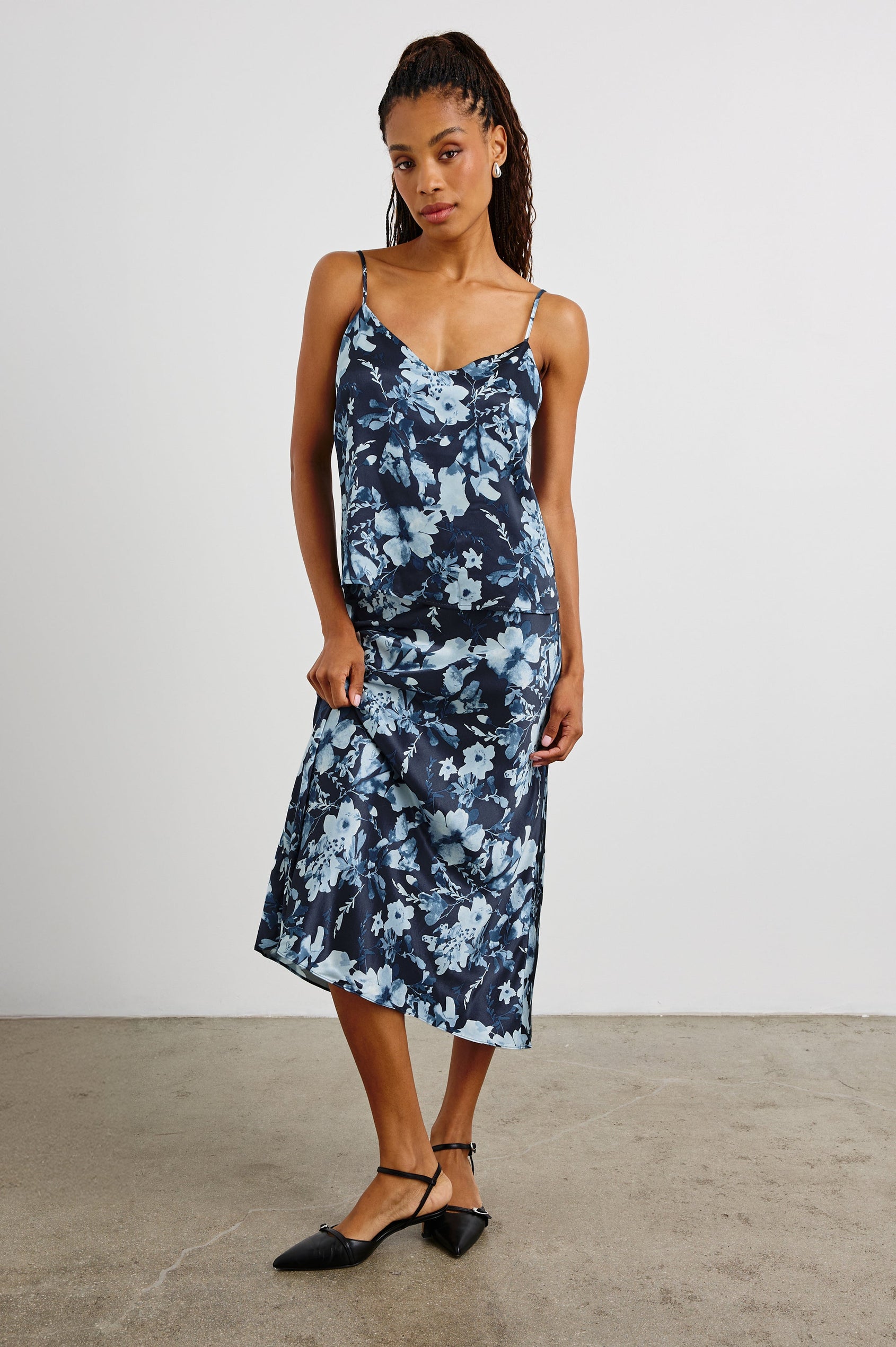 Paola Tank Top with a Deep V Neck and Adjustable Spaghetti Straps in Indigo Blossoms Colorway, a Floral Pattern in Blues on Black - Front Full Body View Featured on Model