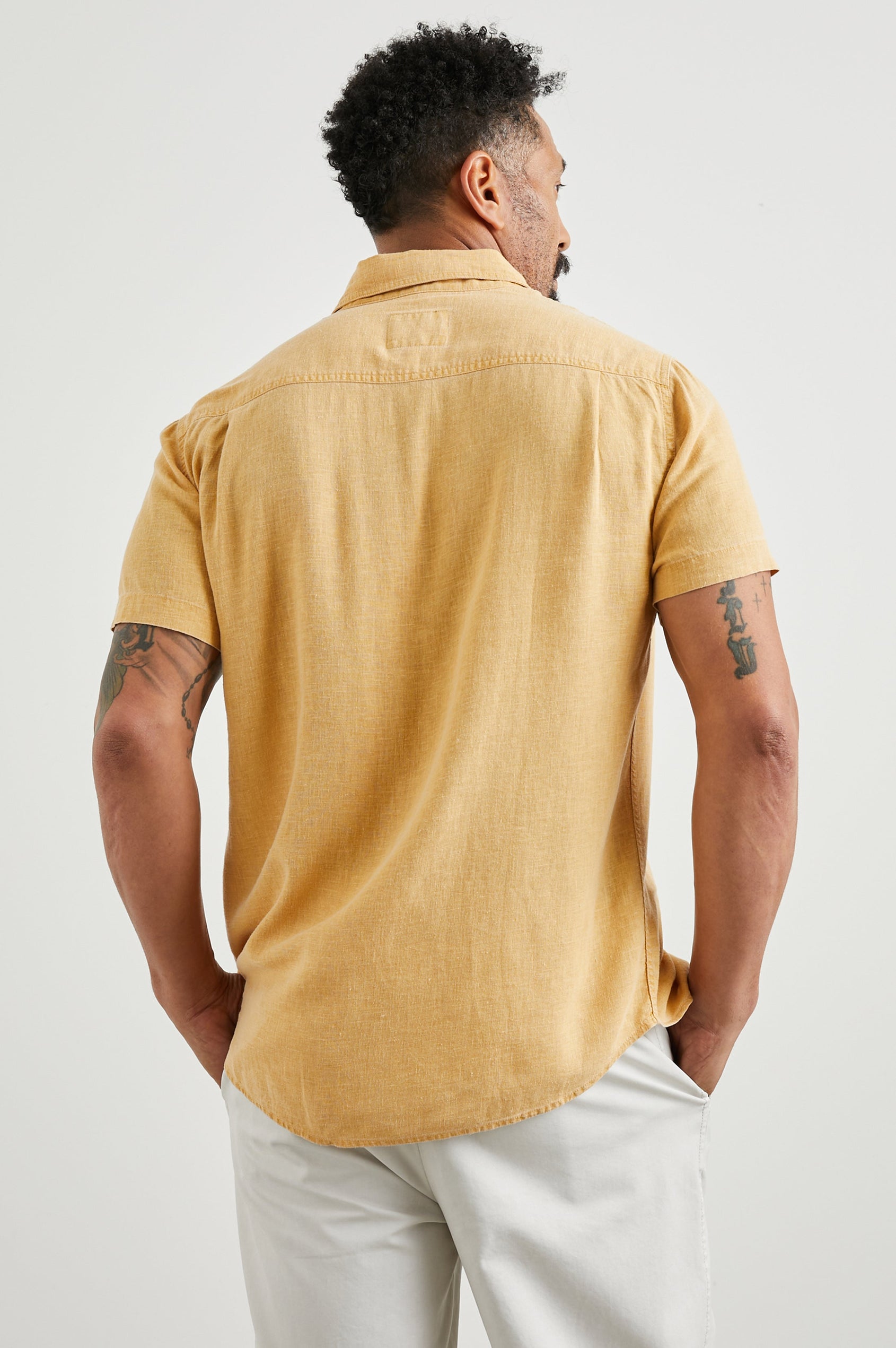 Paros Short-Sleeve Button Up with a Chest Patch Pocket in Uni Colorway, a Yellow - Back View Featured on Model