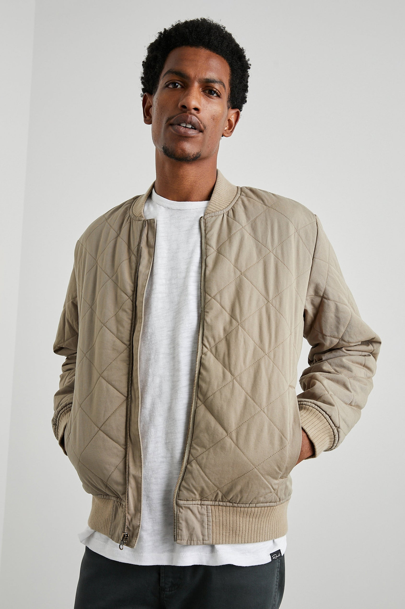 Peninsula Jacket with Zip Closure, Two Front Pockets, an Inner Zippered Pocket, a Quilted Pattern and Ribbed Trim in Vintage Khaki Colorway - Front View Featured on Model