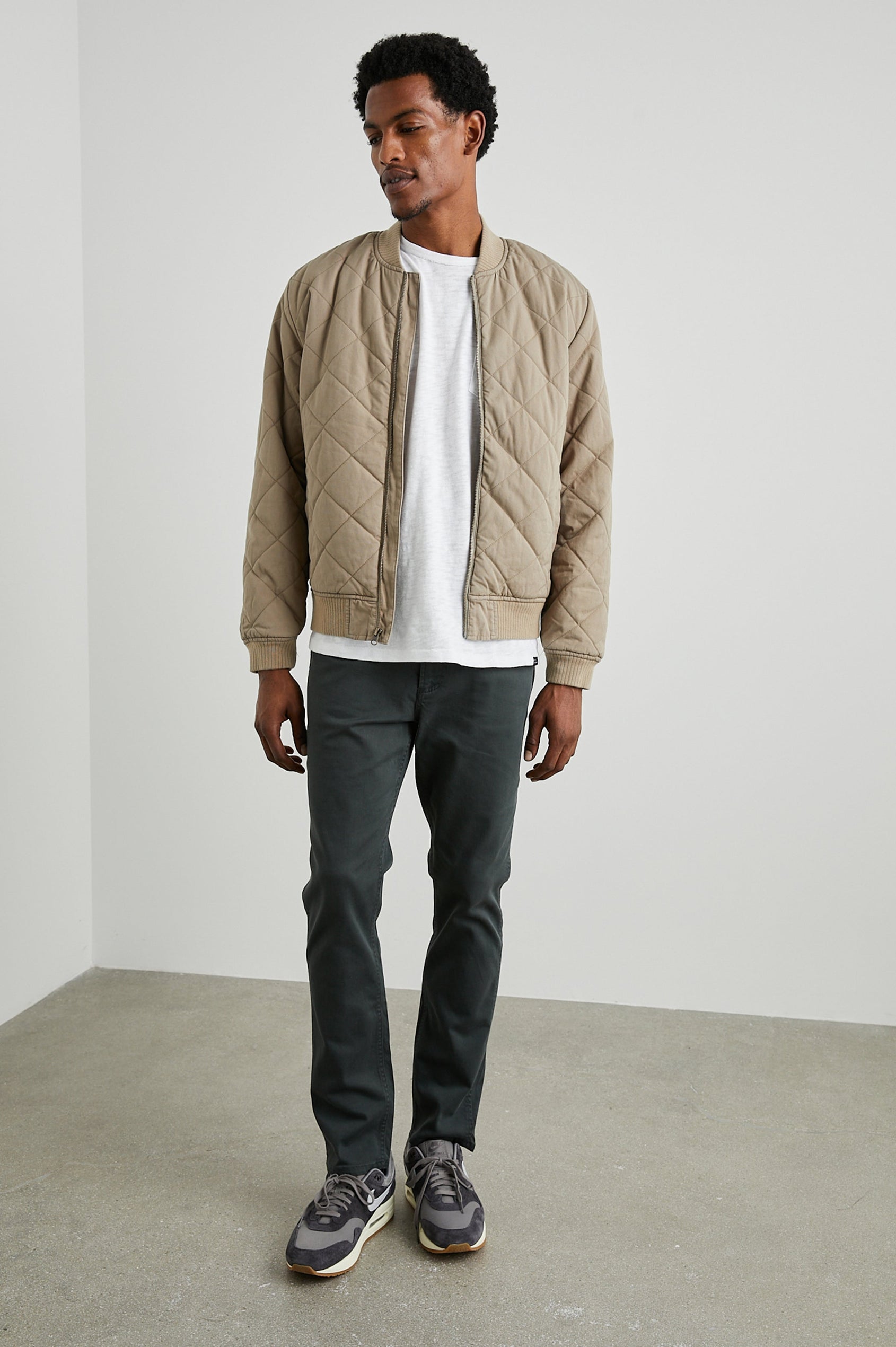 Peninsula Jacket with Zip Closure, Two Front Pockets, an Inner Zippered Pocket, a Quilted Pattern and Ribbed Trim in Vintage Khaki Colorway - Front Full Body View Featured on Model
