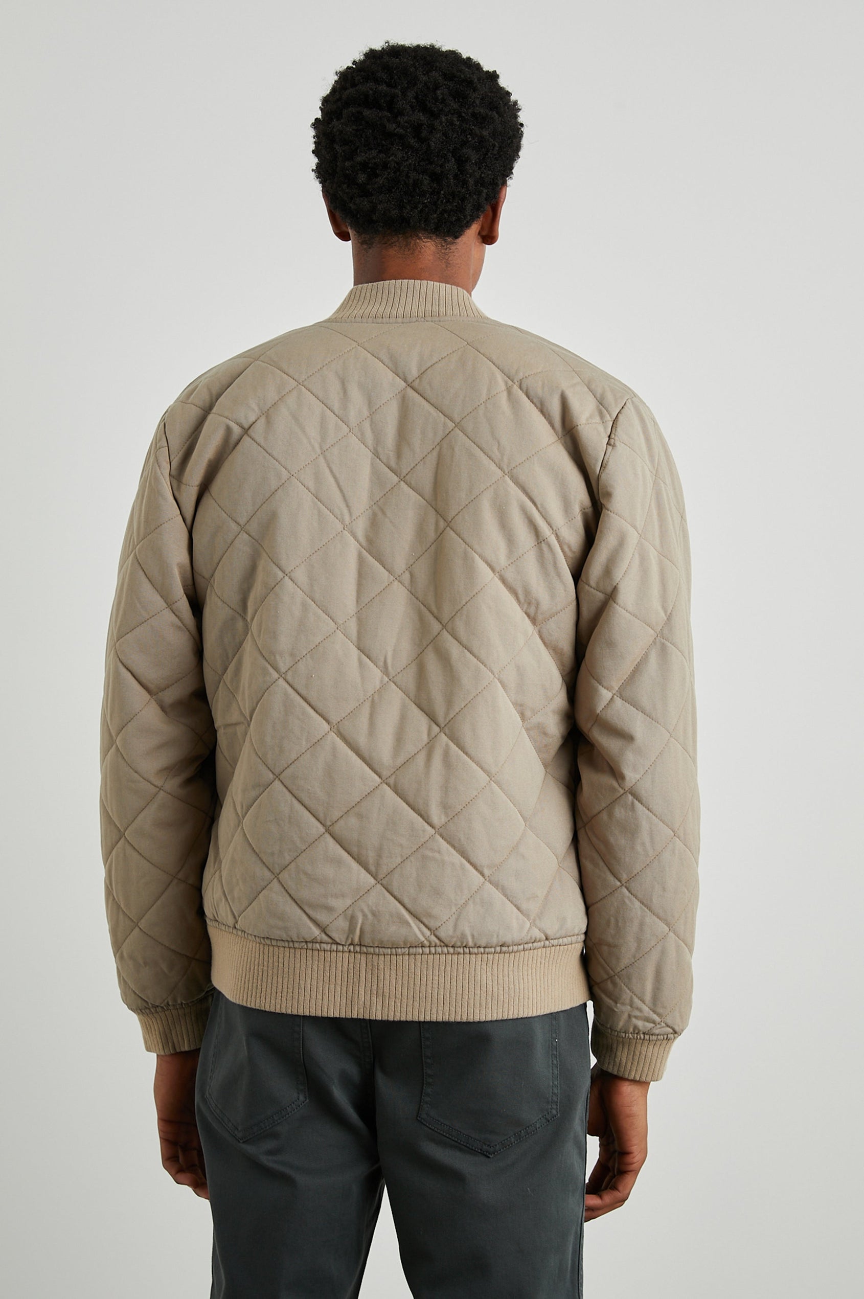 Peninsula Jacket with Zip Closure, Two Front Pockets, an Inner Zippered Pocket, a Quilted Pattern and Ribbed Trim in Vintage Khaki Colorway - Back View Featured on Model