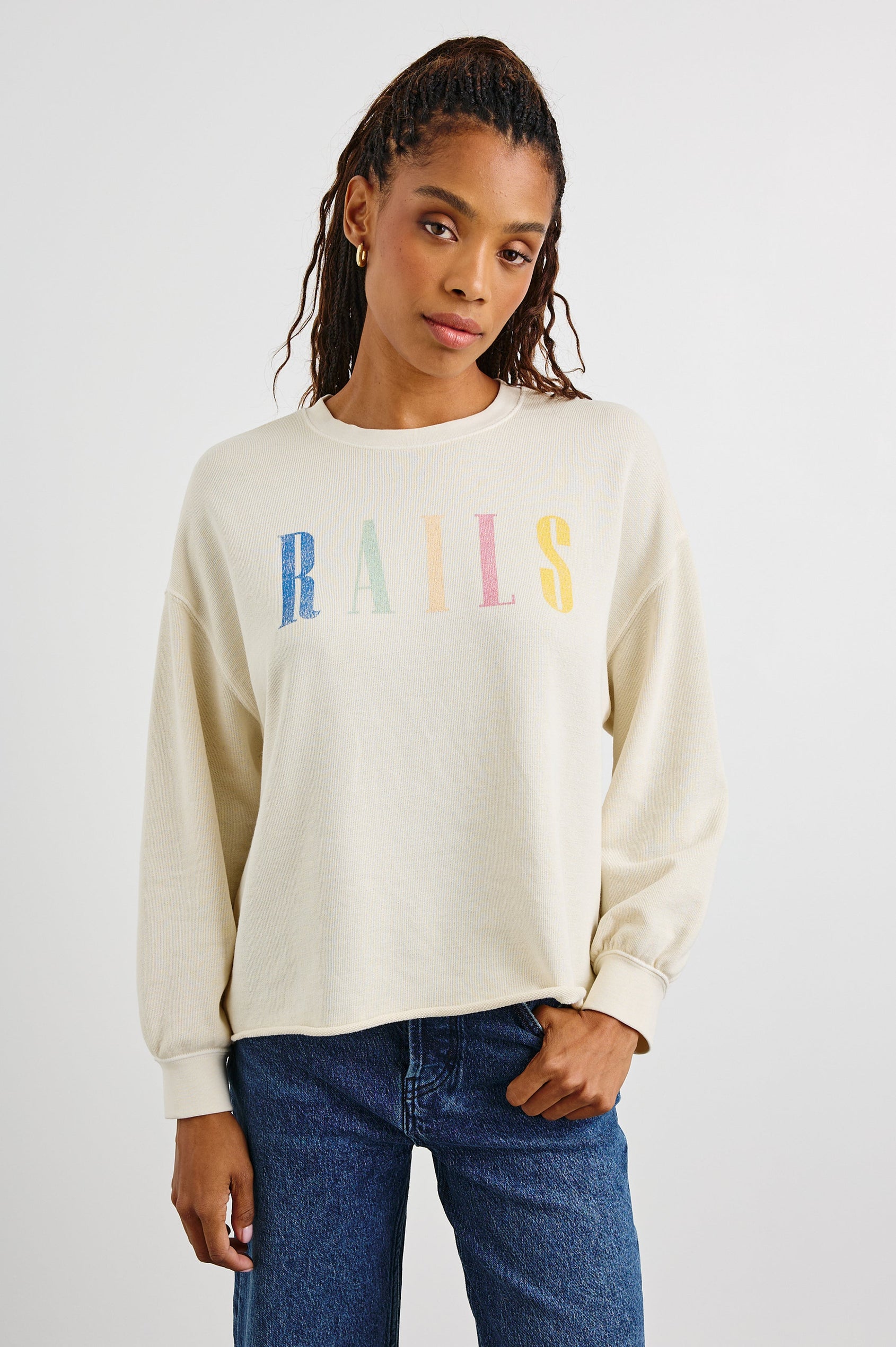 Rails Signature Long-Sleeve Sweatshirt with a Crew Neck, Raw Hem, Shirring Above Cuff, and the Text, Rails, in Ivory Colorway, with Multi Colored Text - Front View Featured on Model
