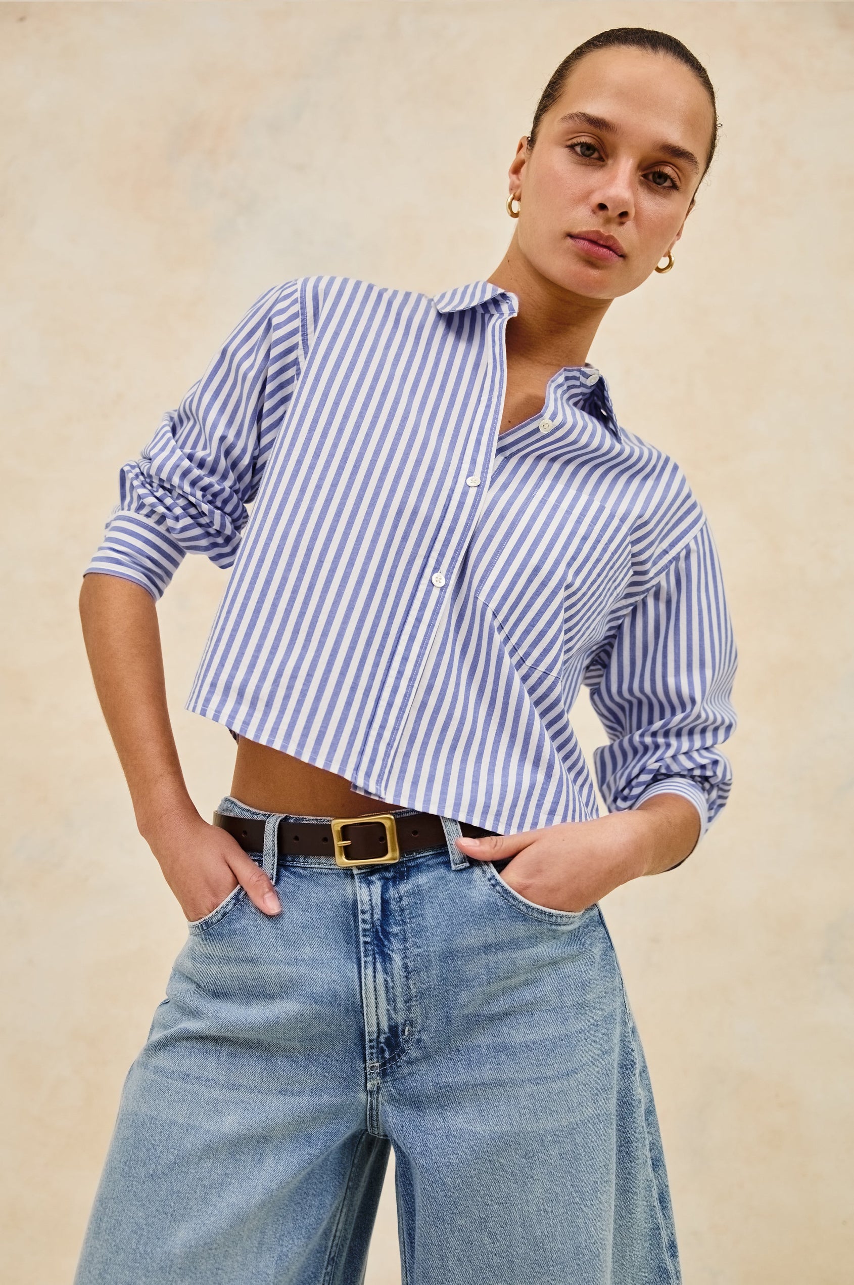 Ramy Long Sleeve Poplin Cotton Shirt With Shortened Hem In Colorway Mariner White Stripe - Front View Featured On Model Hands In Pockets leaning back