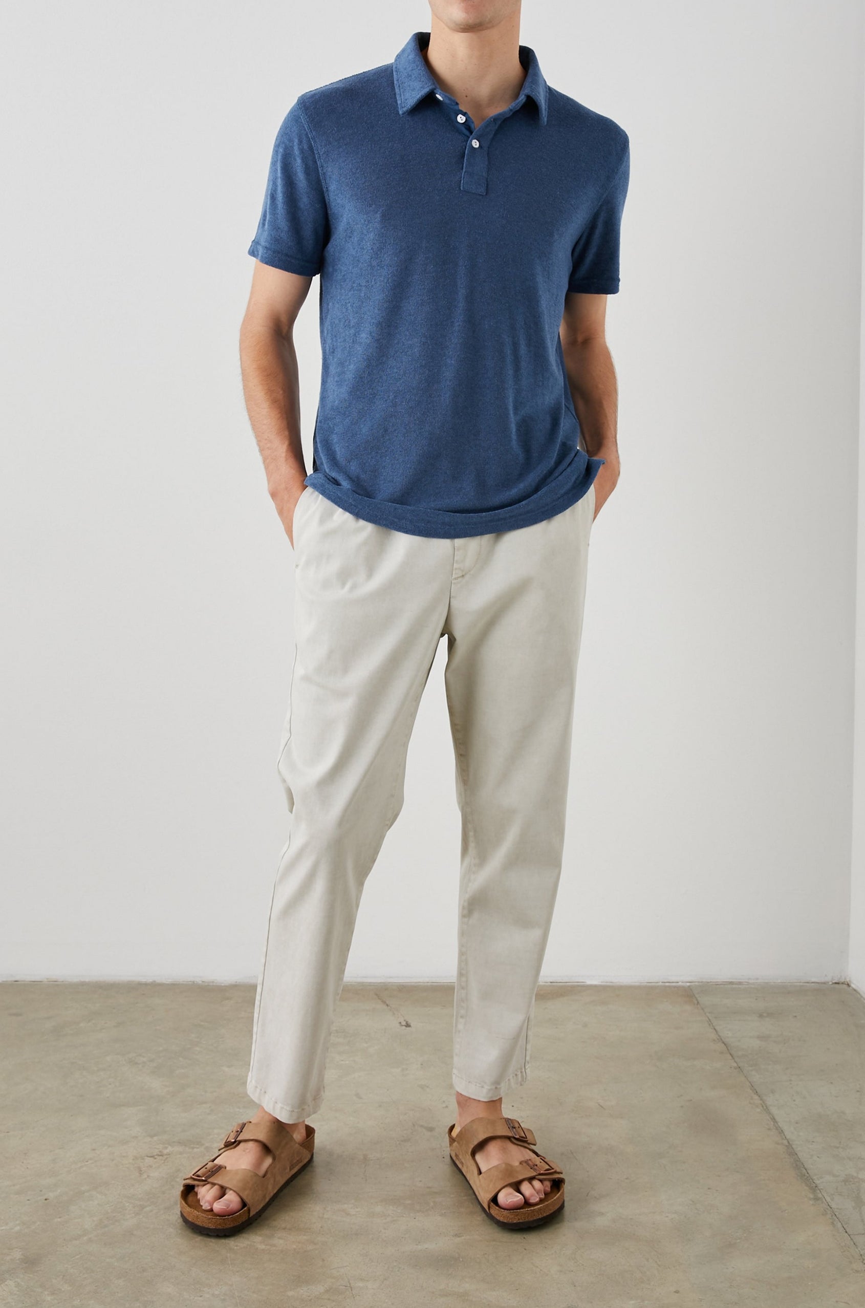 Rhen Short-Sleeve Polo Shirt with a Three-Button Placket in Ensign Blue Colorway - Front Full Body View Featured on Model