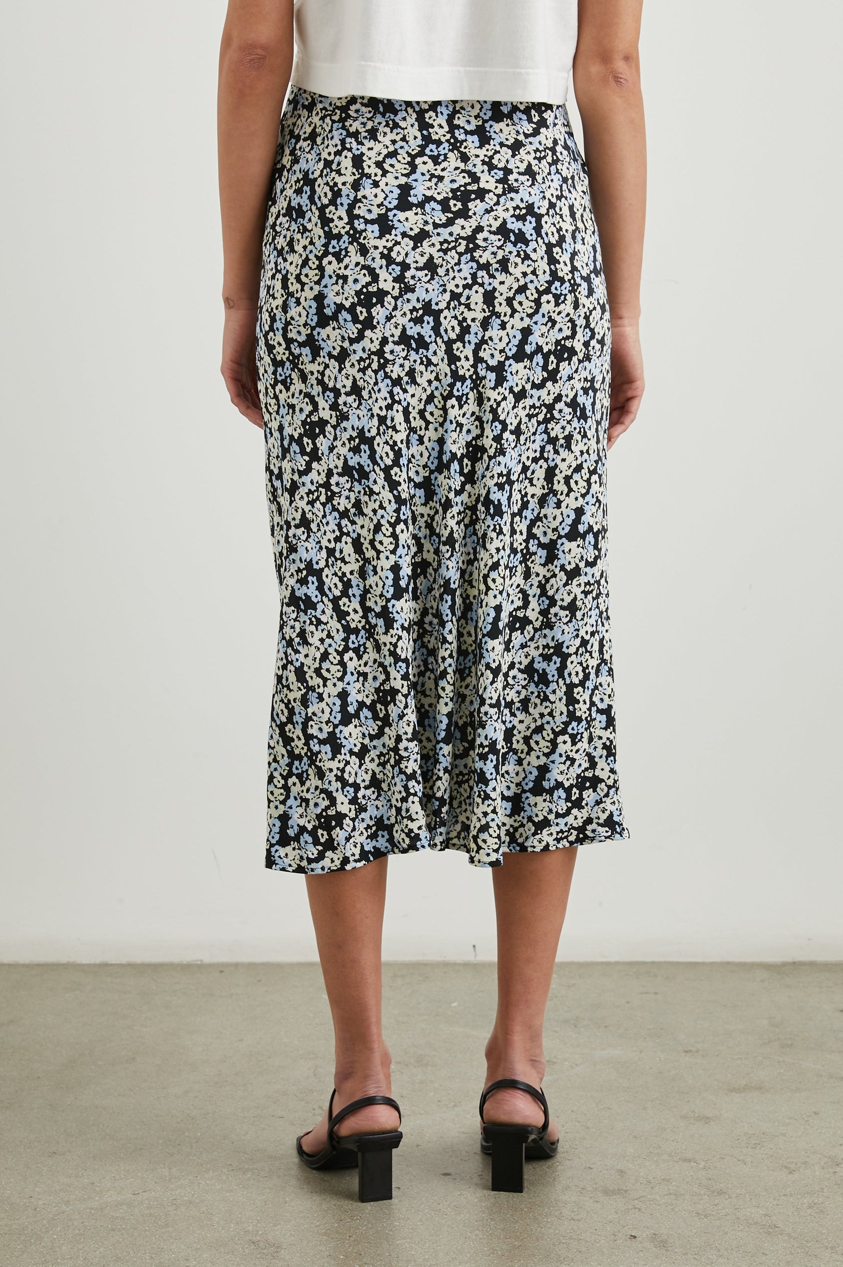 Rosetta Midi Skirt with Buttons Down the Front in Midnight Meadow Floral Colorway, blue and white flowers on Midnight - Back View Featured on Model