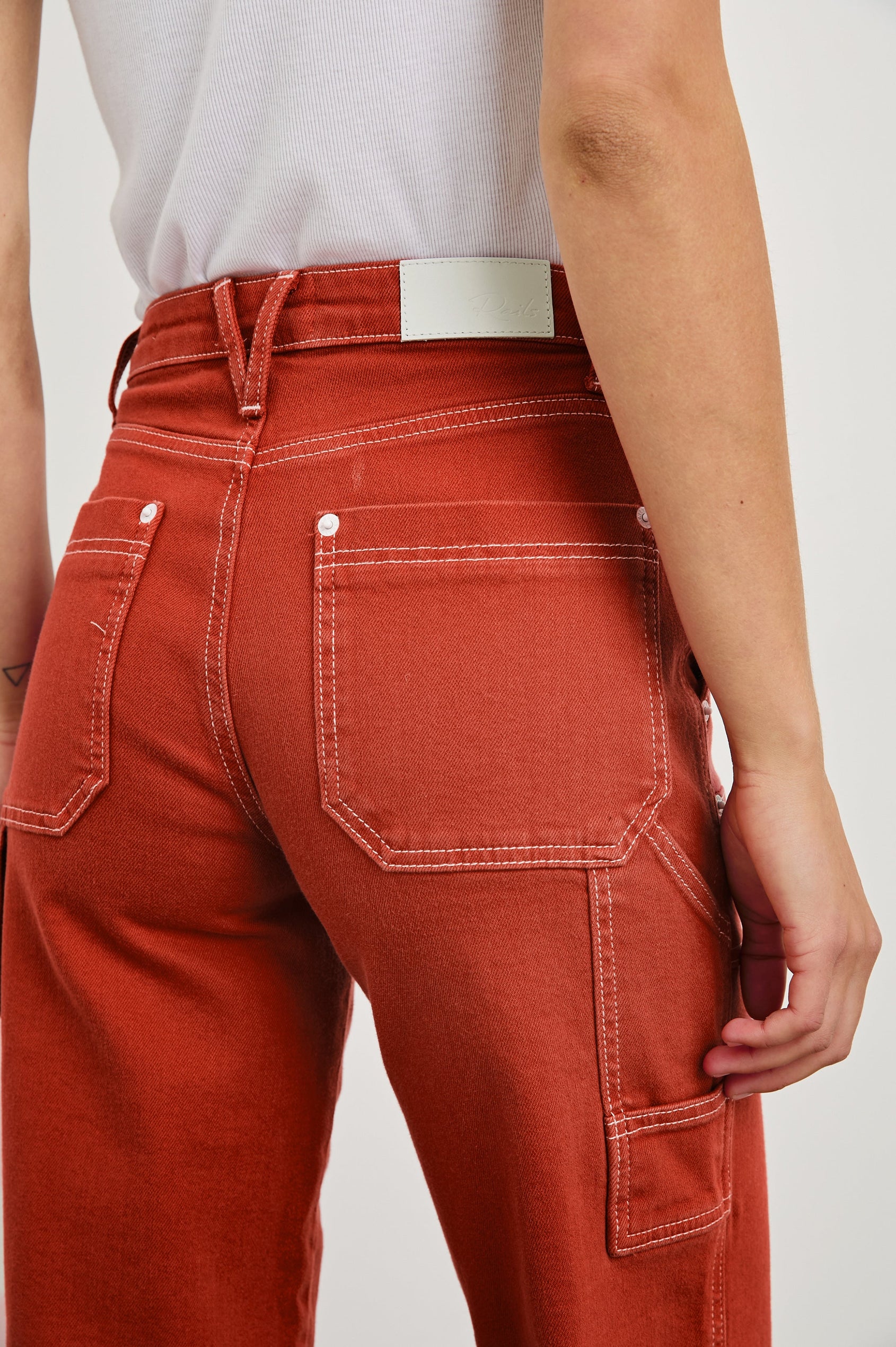 Silverado high rise wide leg crop pant with carpenter style details and contrast stitching in Terracotta - close up of back details on model