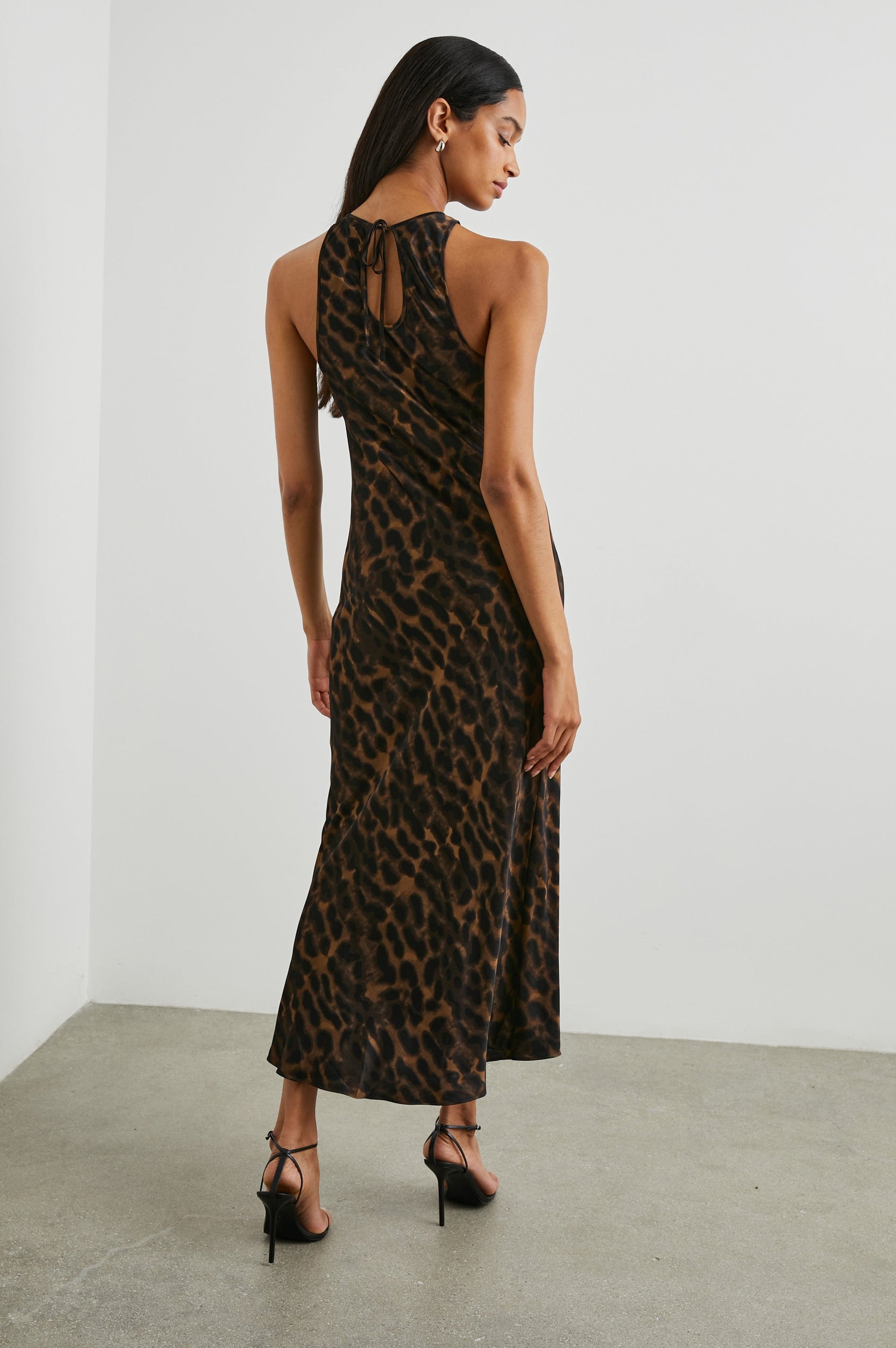 Solene Sleeveless Midi Dress with a Crew Neck and a Tie Keyhole at the Back in Umber Leopard Colorway, Black Leopard Spots on Umber - Back Full Body View Featured on Model