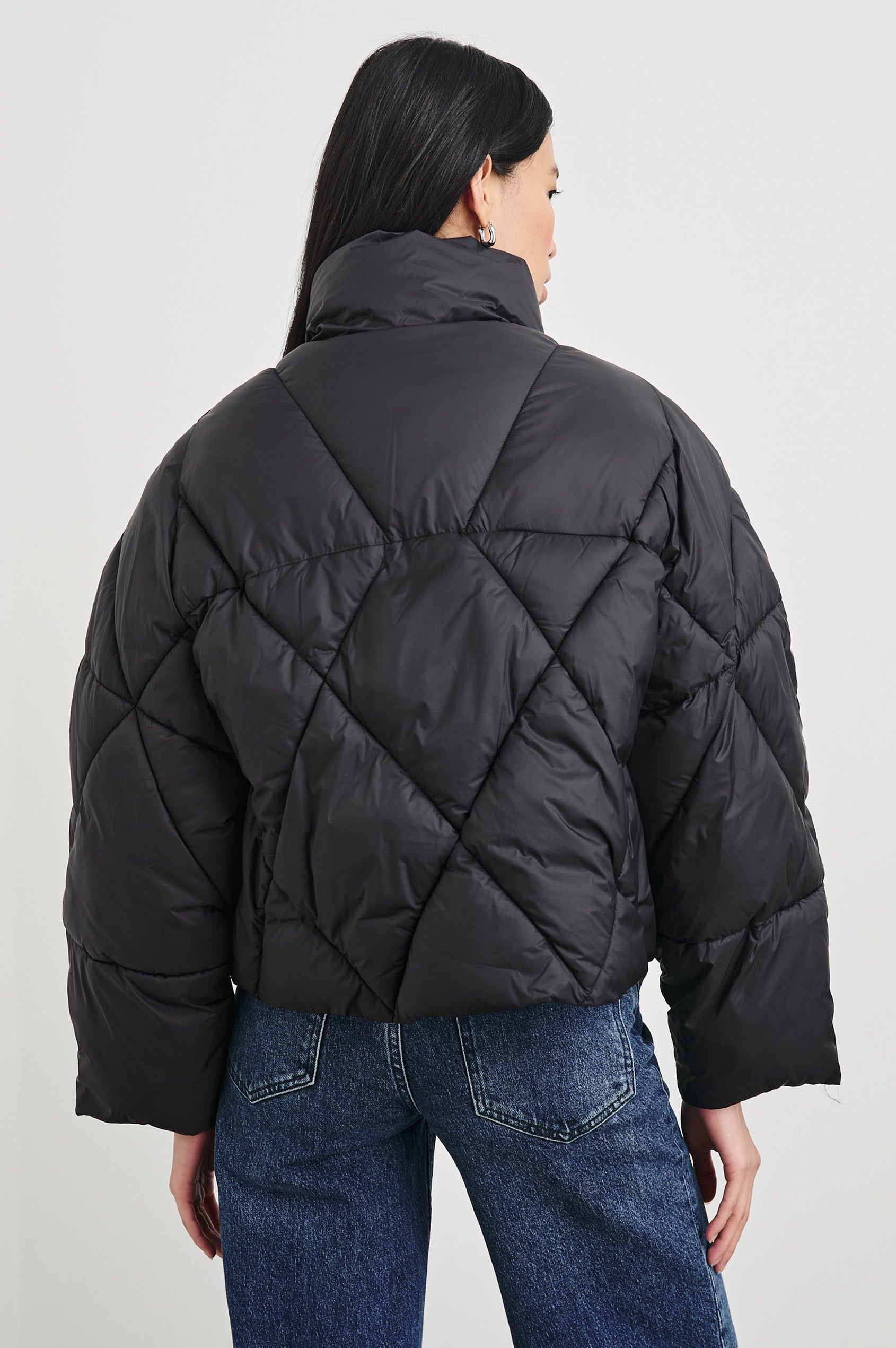 Summit Cropped Puffer Jacket with a Mid-Neck Collar, Two Pockets and a Rails Logo on the Arm in Black Colorway - Back View Featured on Model