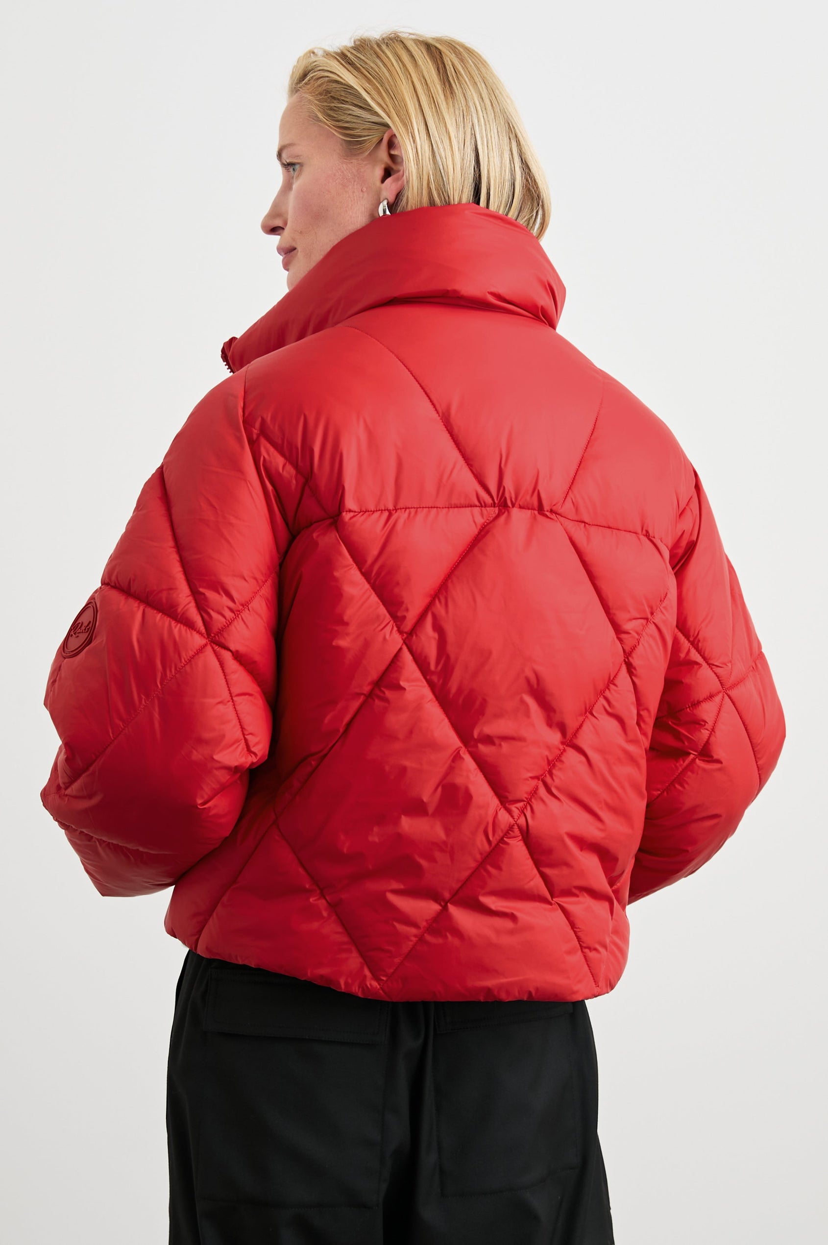Summit Cropped Puffer Jacket with a Mid-Neck Collar, Two Pockets and a Rails Logo on the Arm in Scarlet Colorway - Back View Featured on Model