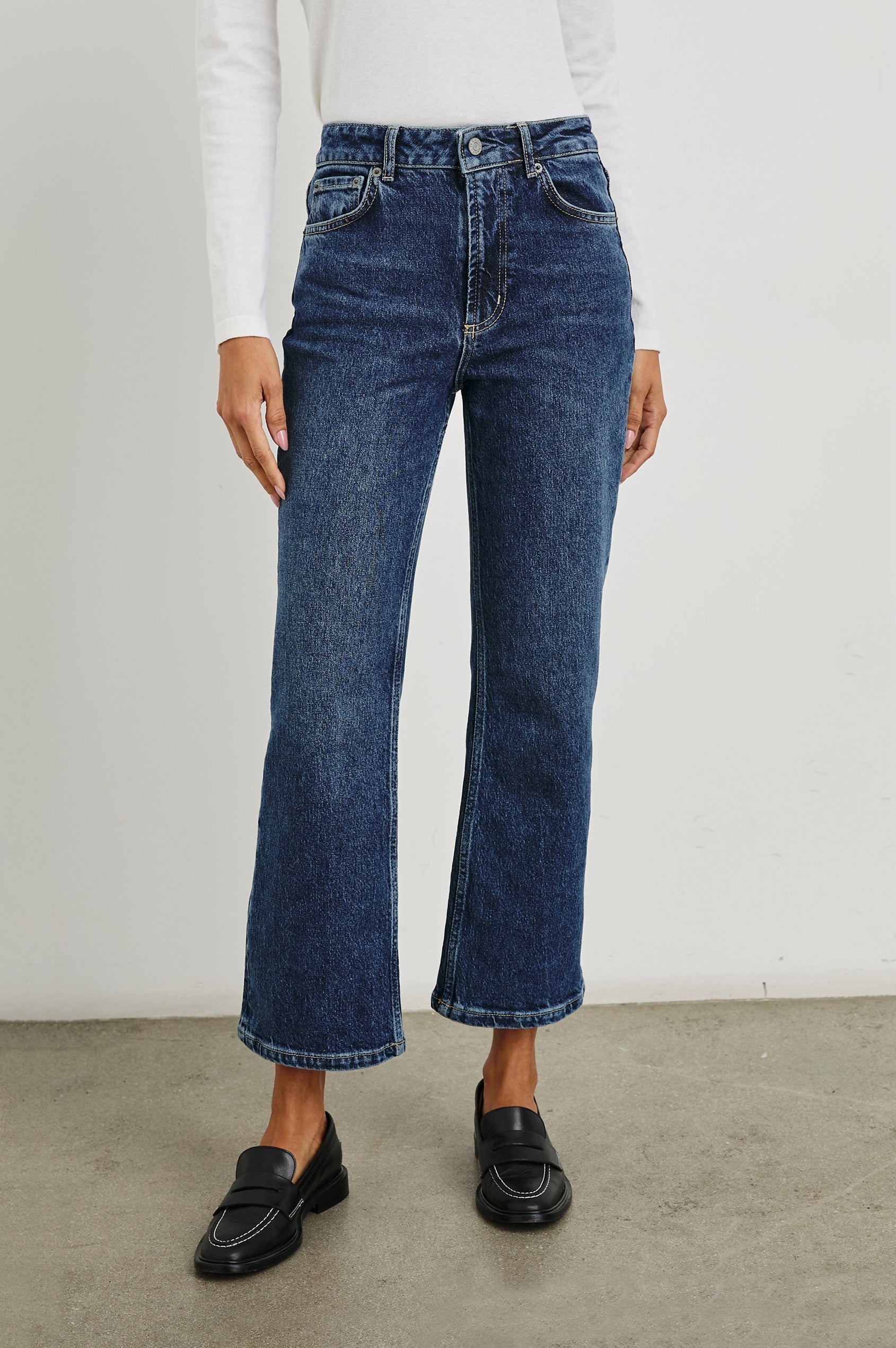 Sunset Crop Slim Fare Jeans with Belt Loops, Two Front Pockets plus a Coin Pocket and Two Back Patch Pockets in Collegiate Blue Colorway - Front View Featured on Model