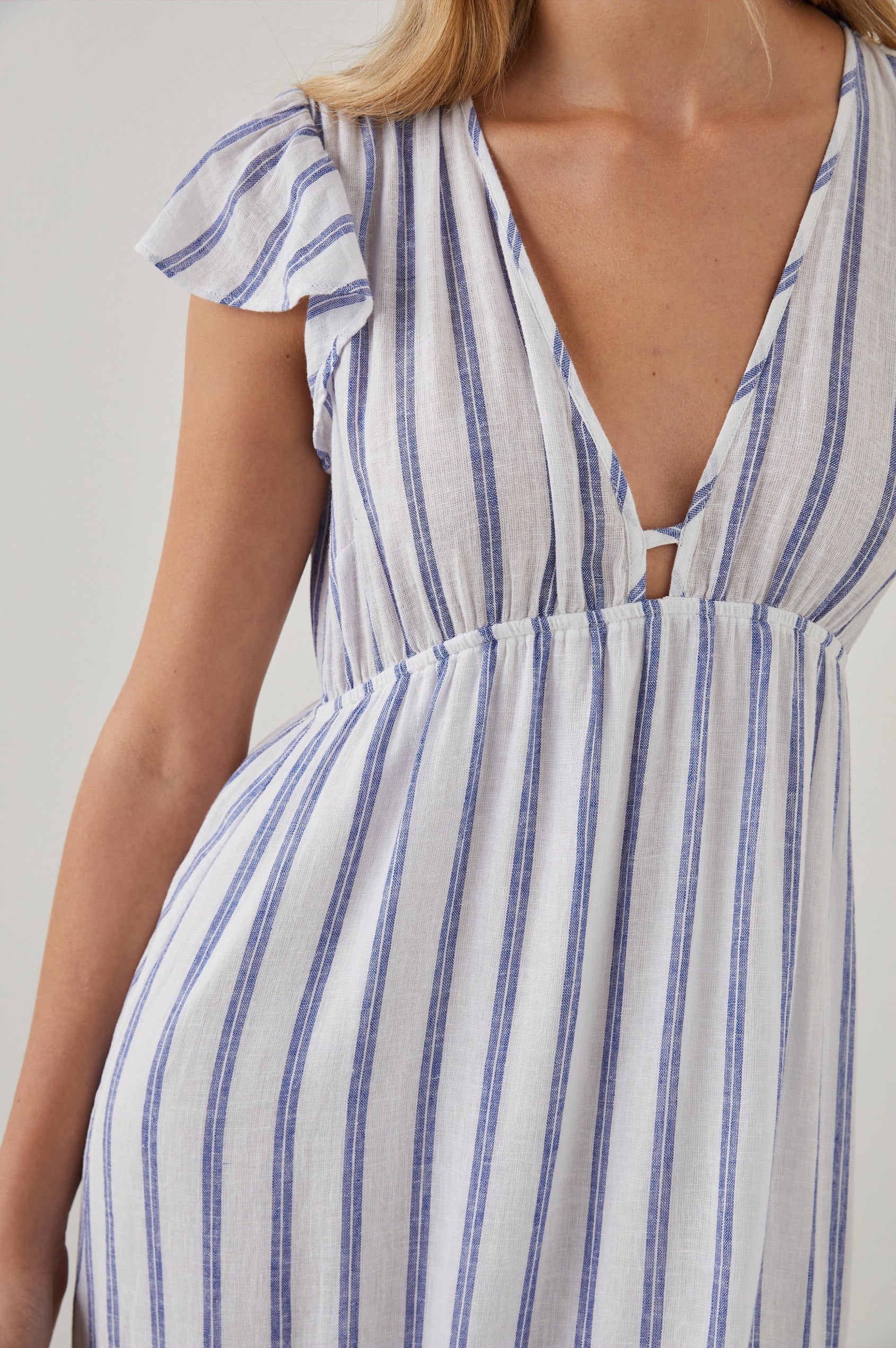 Tina Short Sleeve Midi Dress with Flutter Sleeves, a Deep V Neck with a Cutout and a Tiered Skirt in Villa Stripe Colorway, with Thin Vertical Blue Stripes on White - Front View Featured on Model