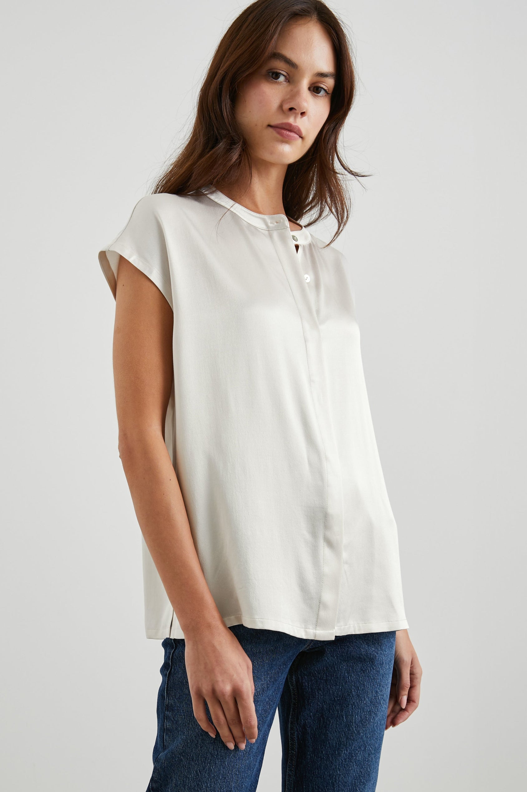 Uma Short Sleeve Top with Concealed Buttons Down the Front and Cap Sleeves in Ivory Colorway - Front View Featured on Model