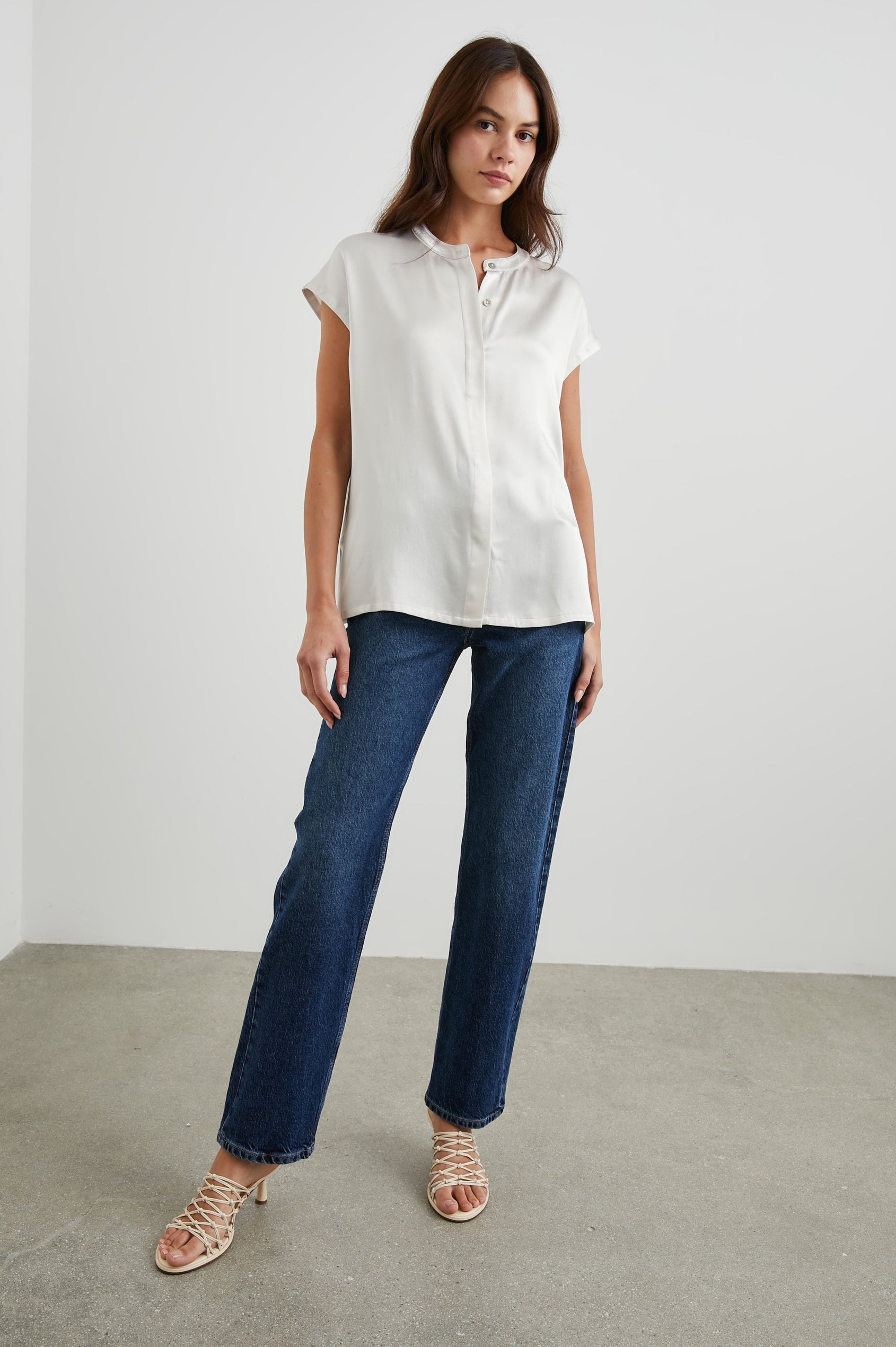 Uma Short Sleeve Top with Concealed Buttons Down the Front and Cap Sleeves in Ivory Colorway - Front Full Body View Featured on Model