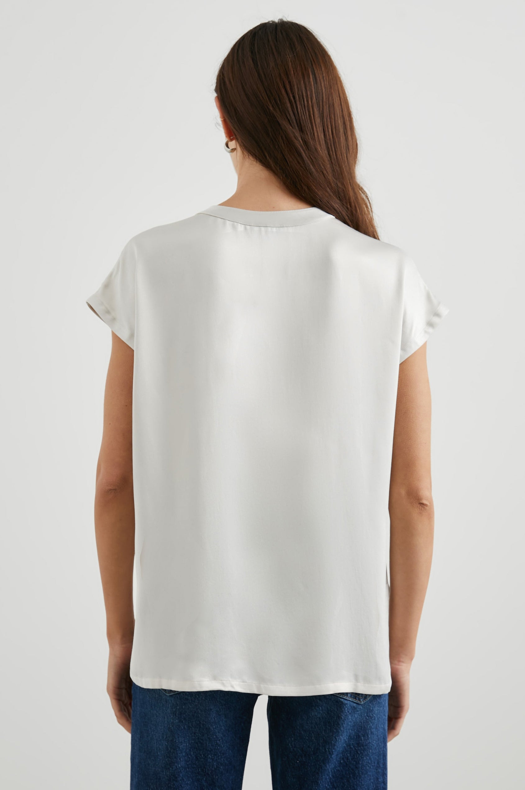Uma Short Sleeve Top with Concealed Buttons Down the Front and Cap Sleeves in Ivory Colorway - Back View Featured on Model