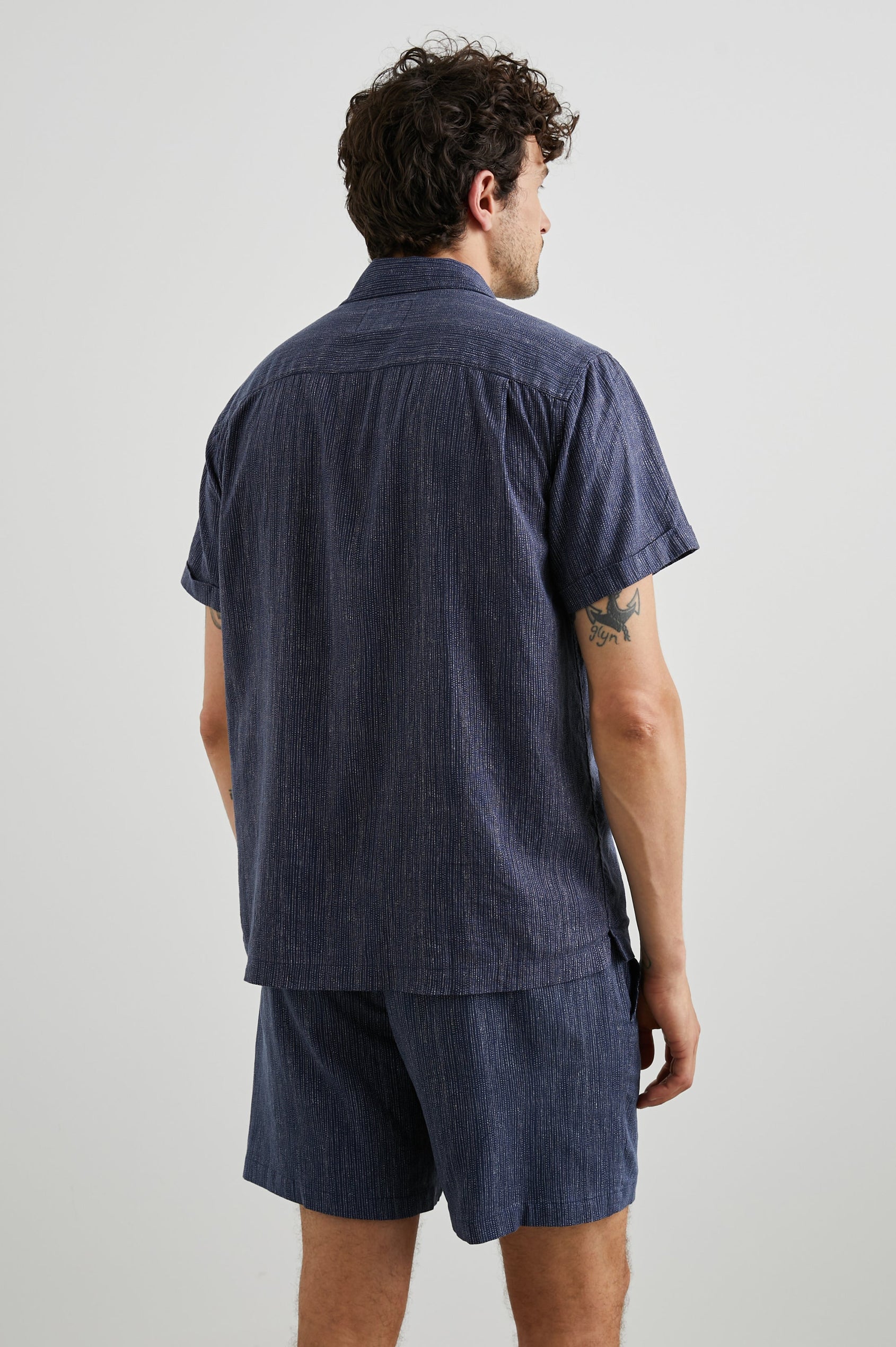 Waimea Short-Sleeve Button Up with a Chest Patch Pocket in Matrix Navy Pearl Colorway, with thin pearl vertical dashes on navy - Back View Featured on Model