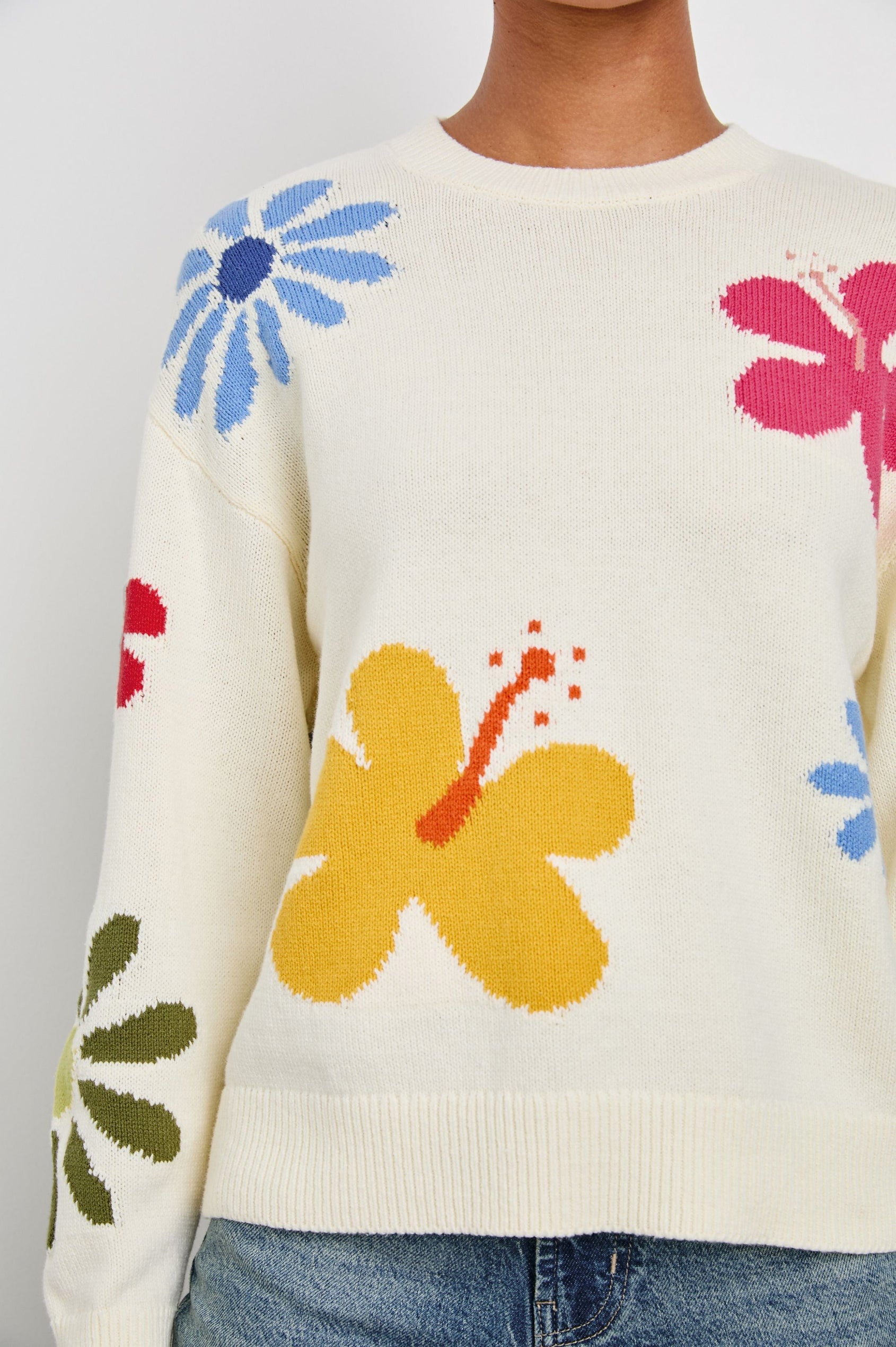 Zoey Long Sleeve Crew Neck Sweater With Multiple Colored Flowers In Colorway Ivory Hibiscus - Detail View Featured On Model