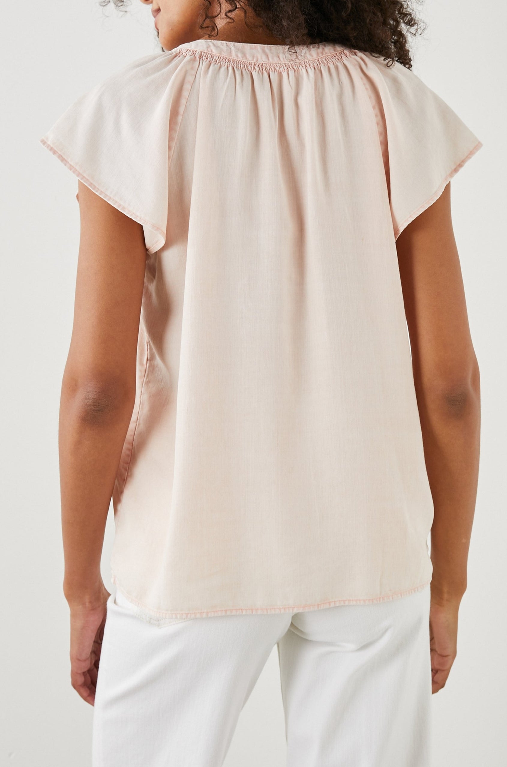 Alena Short Sleeve Top with Flutter Sleeves, a V Neck, Buttons Down the Bodice and Ruching along the Collar in Petal Colorway - Back View Featured on Model