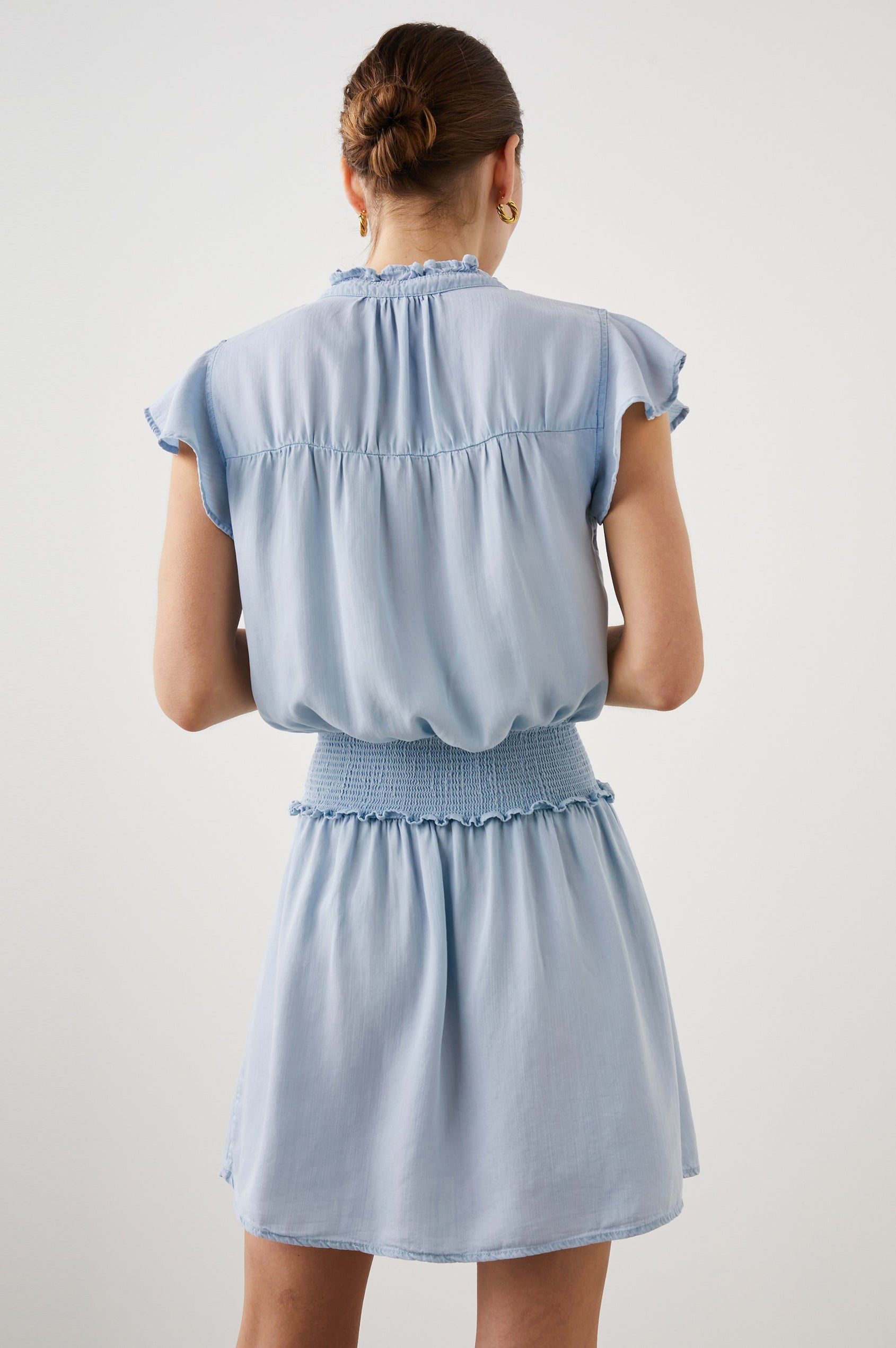 Amina Short Sleeve Mini Dress with Flutter Sleeves, a Ruffled Collar with Ruching, a Button Placket, and a Shirred Waist in Light Vintage Colorway - Back View Featured on Model