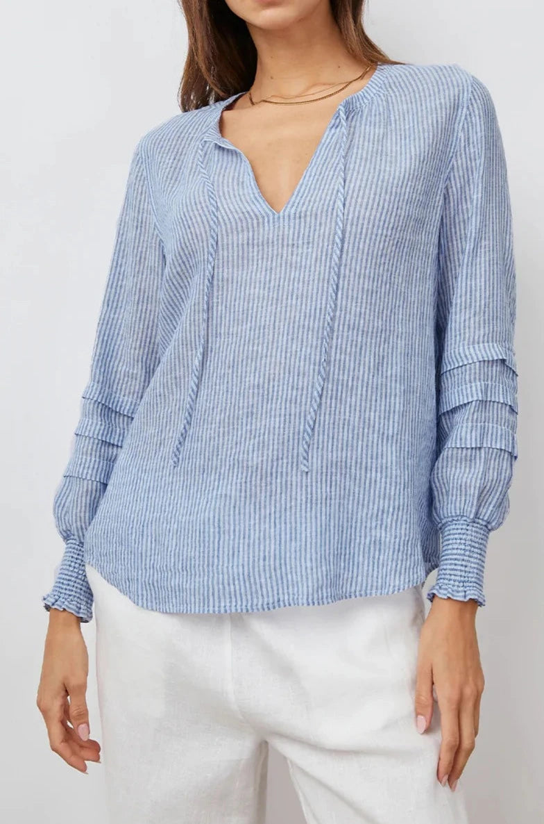 Caterina Long-Sleeve Top with a V neck, Neck Ties, Shirred Cuffs and Horizontal Pleats on the Sleeves in Sanibel Stripe Colorway, Thin White and Blue Vertical Stripes - Front View Featured on Model