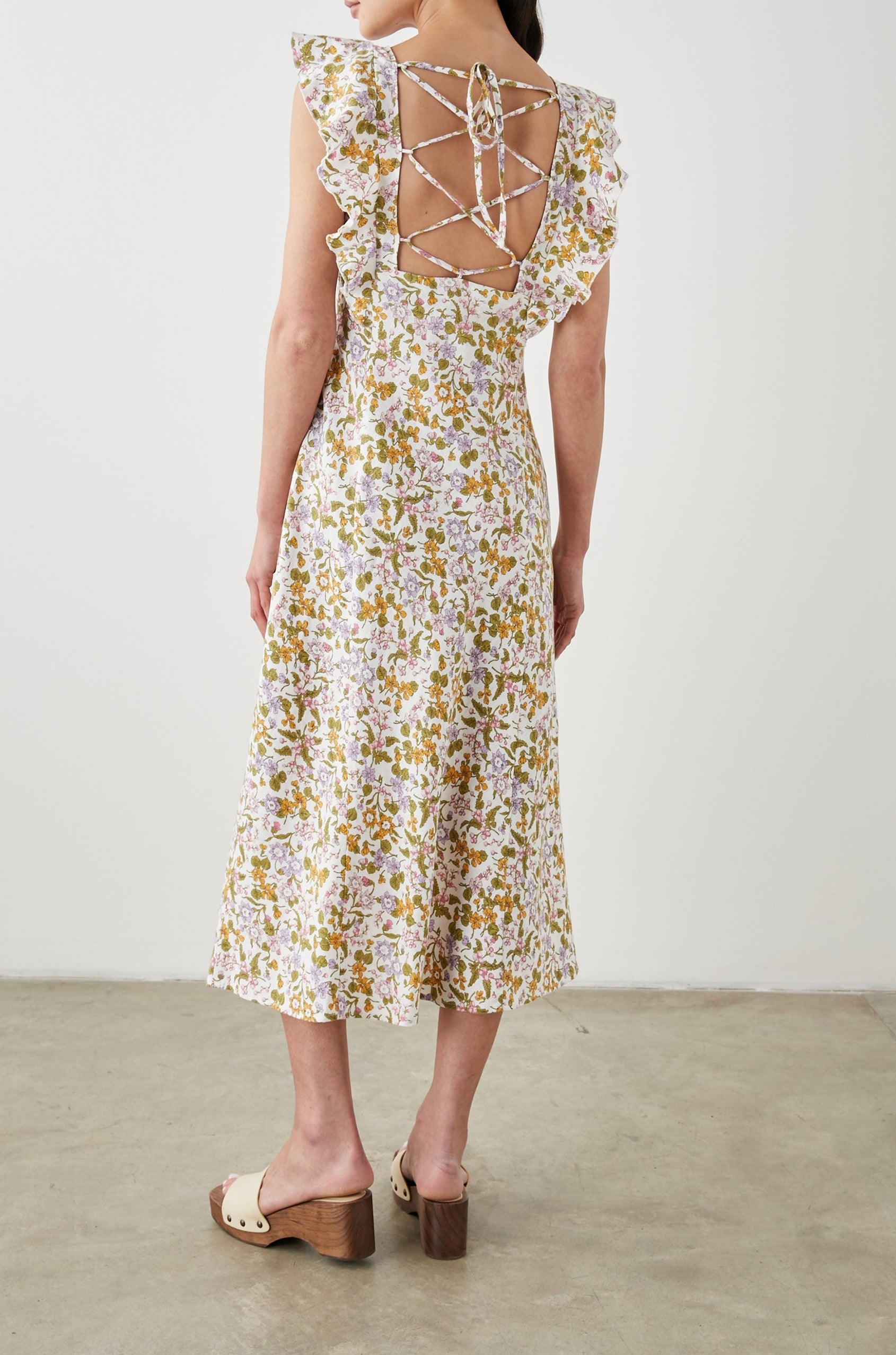 Constance Short Sleeve Midi Dress with Flutter Sleeves, a V Neck, and Cross Ties Across the Mid to Upper Back in Tansy Colorway, Brown, Orange, Purple, Pink and Green on White - Back Full Body View Featured on Model