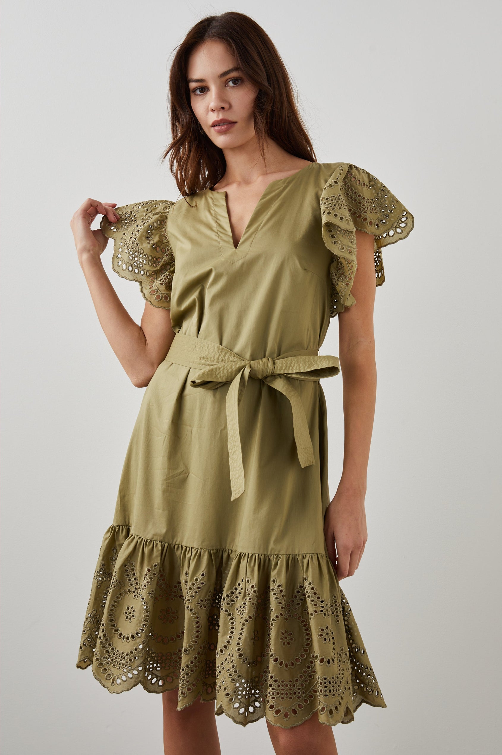 Darlene Short Sleeve, Above-The-Knee Dress with Flutter Sleeves, a V Neck, Adjustable Waist Tie and an Eyelet Design on the Sleeves and Hem in Canteen Colorway - Front View Featured on Model