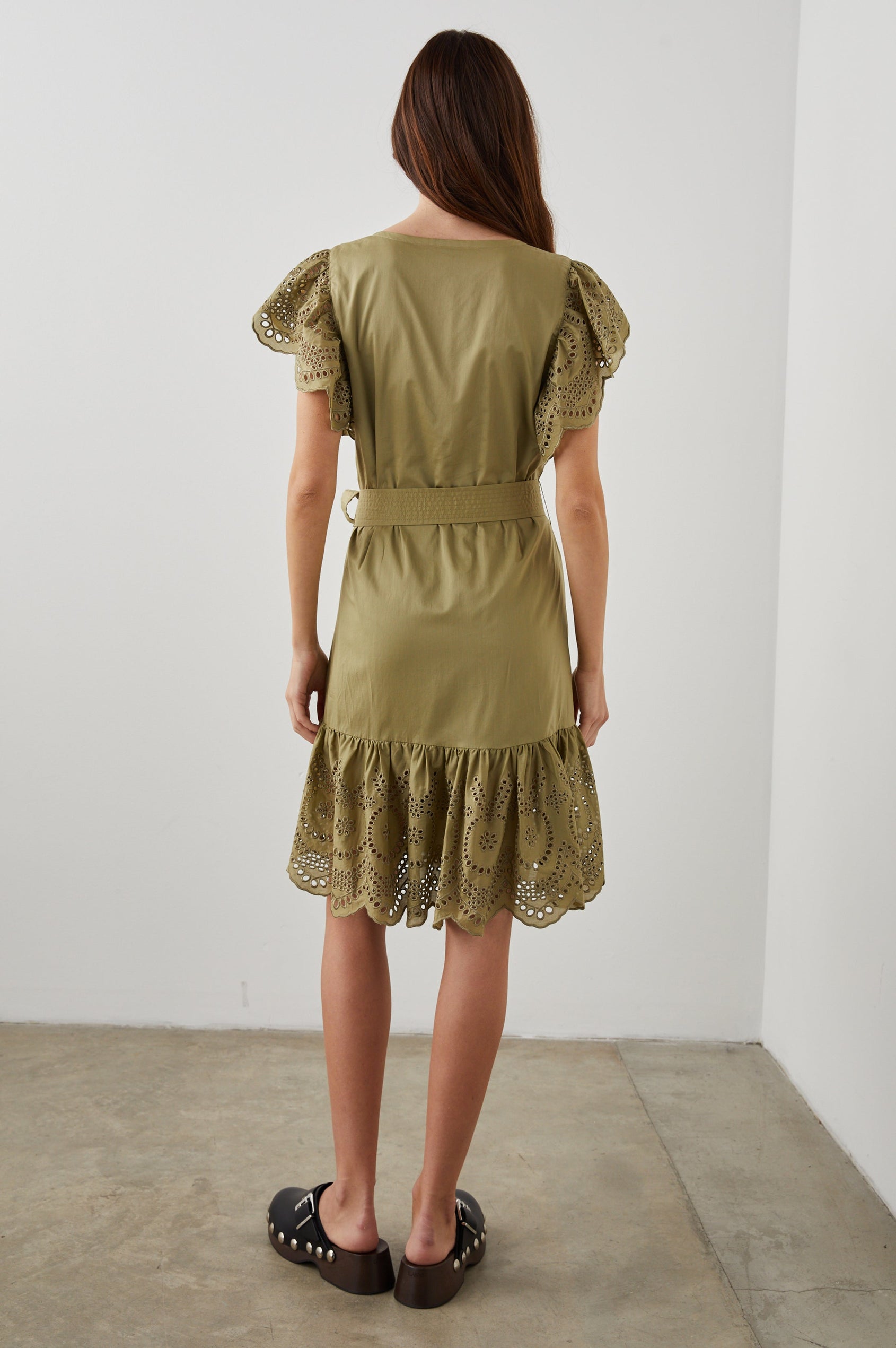 Darlene Short Sleeve, Above-The-Knee Dress with Flutter Sleeves, a V Neck, Adjustable Waist Tie and an Eyelet Design on the Sleeves and Hem in Canteen Colorway - Back Full Body View Featured on Model