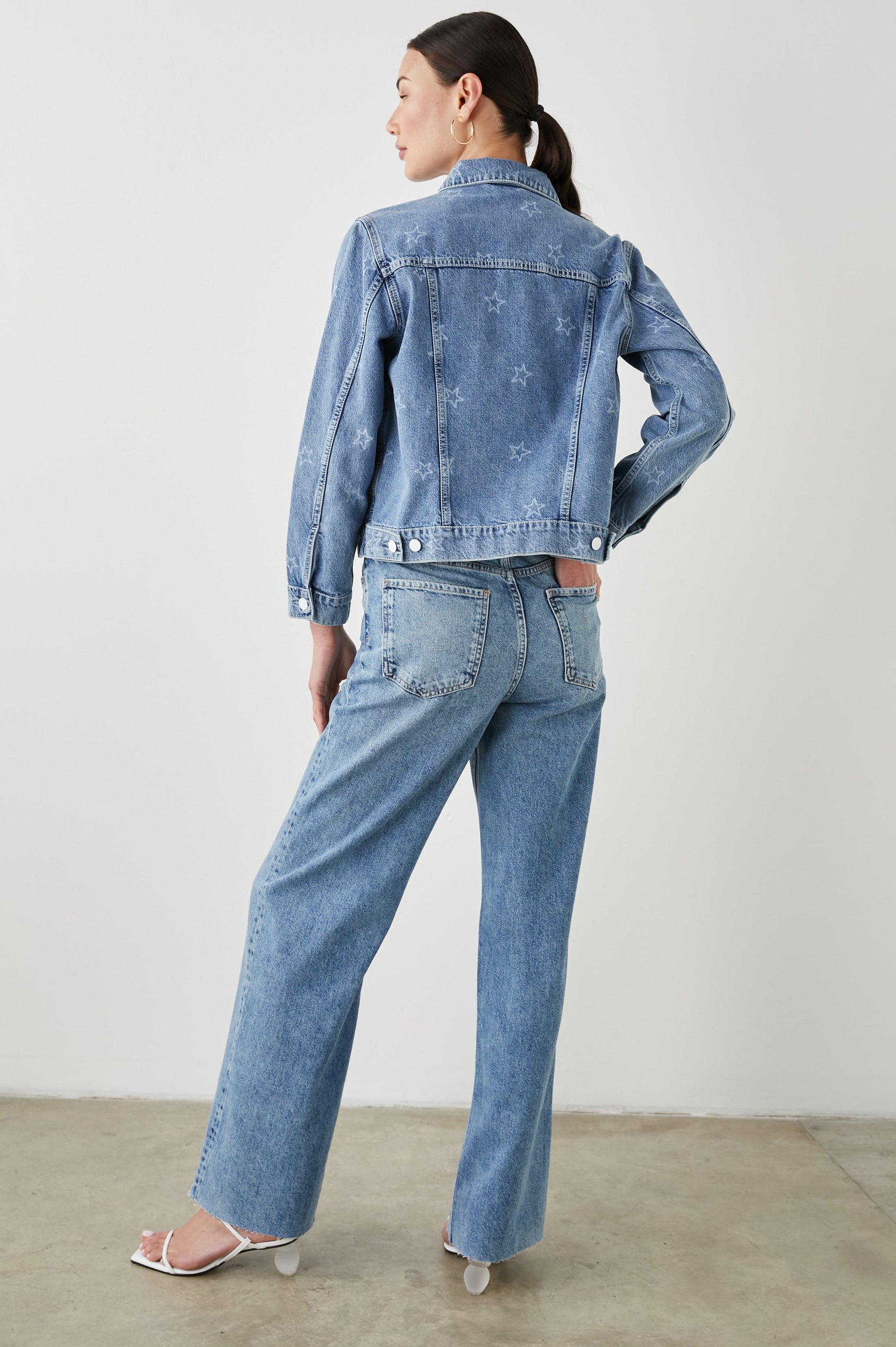 Mulholland Denim Jacket with Button Closure, Two Chest Button Flap Pockets, Two Front Pockets, Adjustable Button Straps on Hem in Lady Liberty Colorway, with White Stars - Back Full Body View Featured on Model