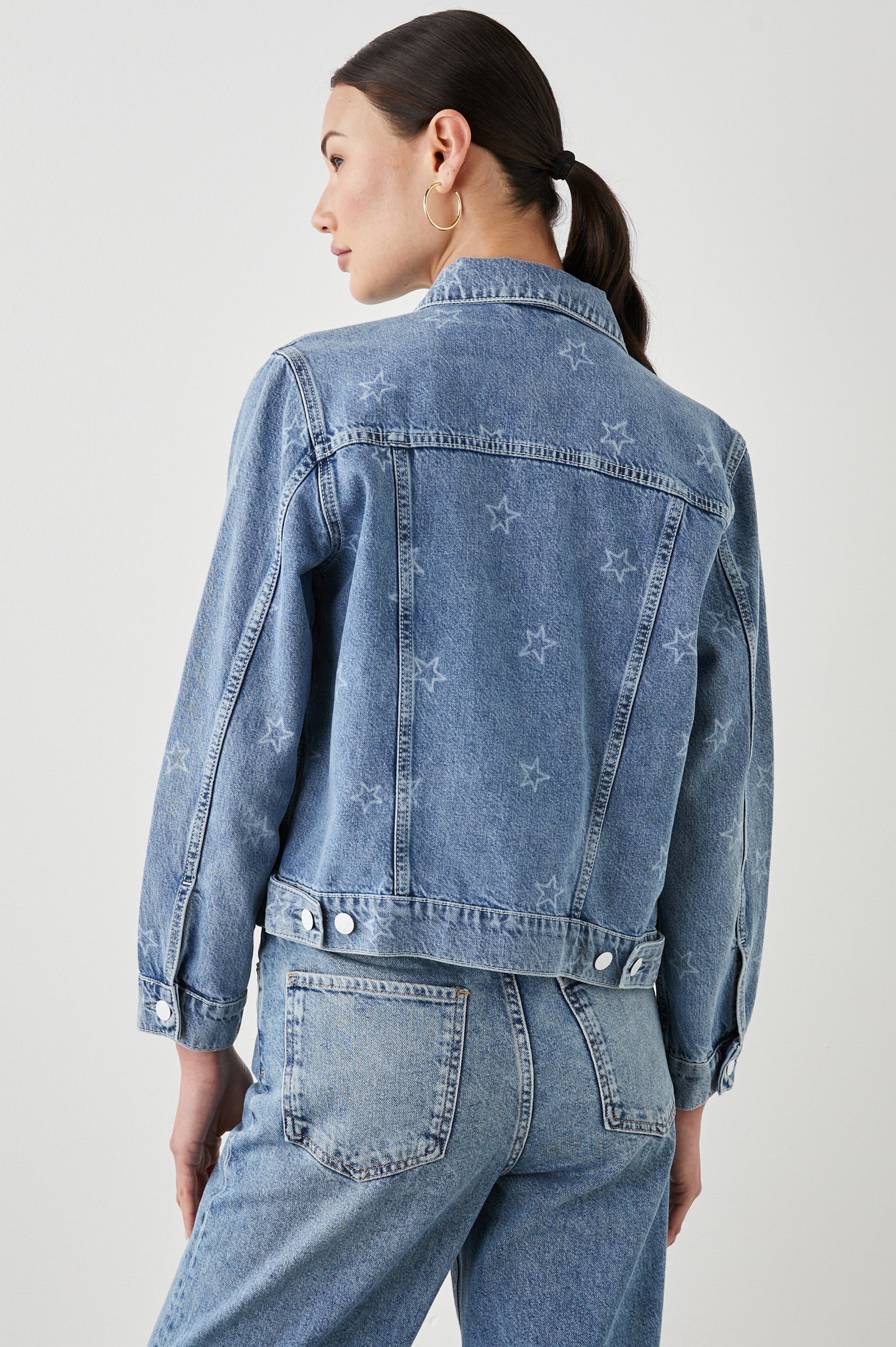 Mulholland Denim Jacket with Button Closure, Two Chest Button Flap Pockets, Two Front Pockets, Adjustable Button Straps on Hem in Lady Liberty Colorway, with White Stars - Back View Featured on Model