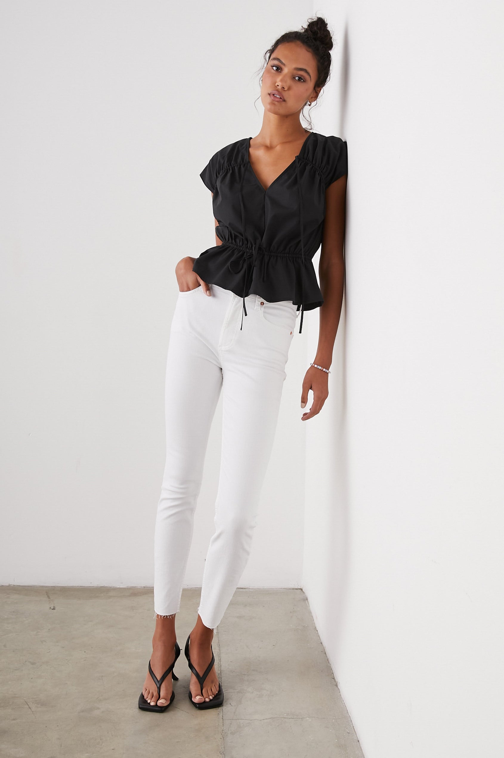 Savi Short-Sleeve Top with a V Neck, Cap Sleeves, a Drawstring From Each Sleeve Shoulder to the Neckline and a Drawstring at the Waist in Black Colorway - Front Full Body View Featured on Model