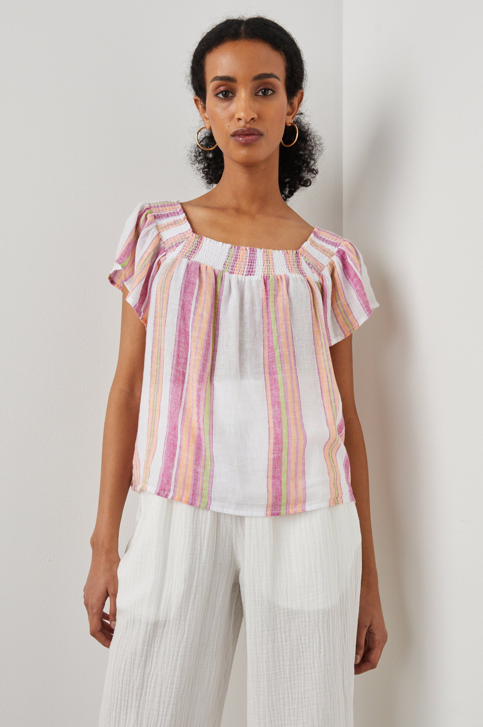 Sonora Short Sleeve Top with a Scoop Neckline and Shirring at the Neckline in Hibiscus Stripe Colorway, Vertical Stripes in Green, Orange, Pink and White - Front View Featured on Model
