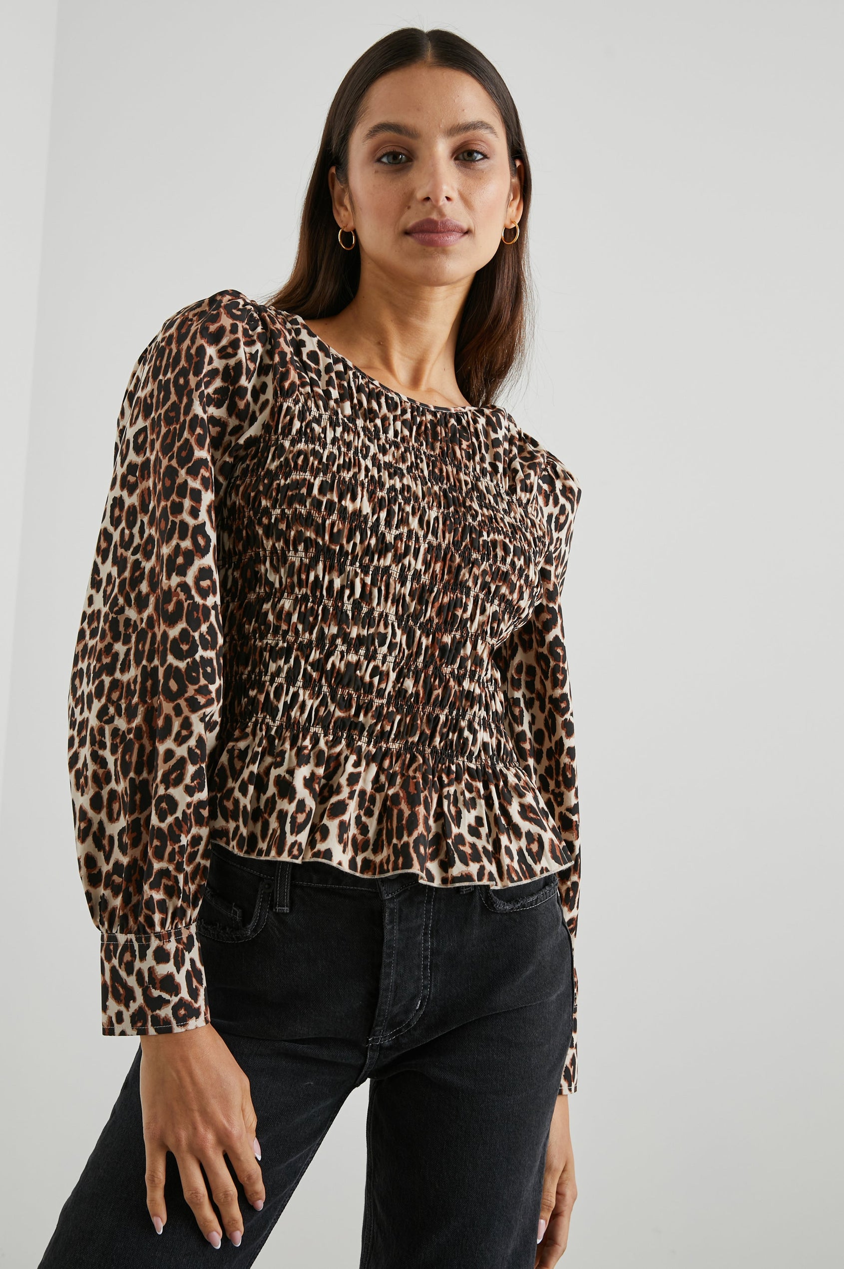 Tari Long-Sleeve Top with Shirring Across the Bodice, a Ruffled Hem, a Scoop Neck and Button Cuffs in Nala Colorway, Brown and Black Spots on White - Front View Featured on Model