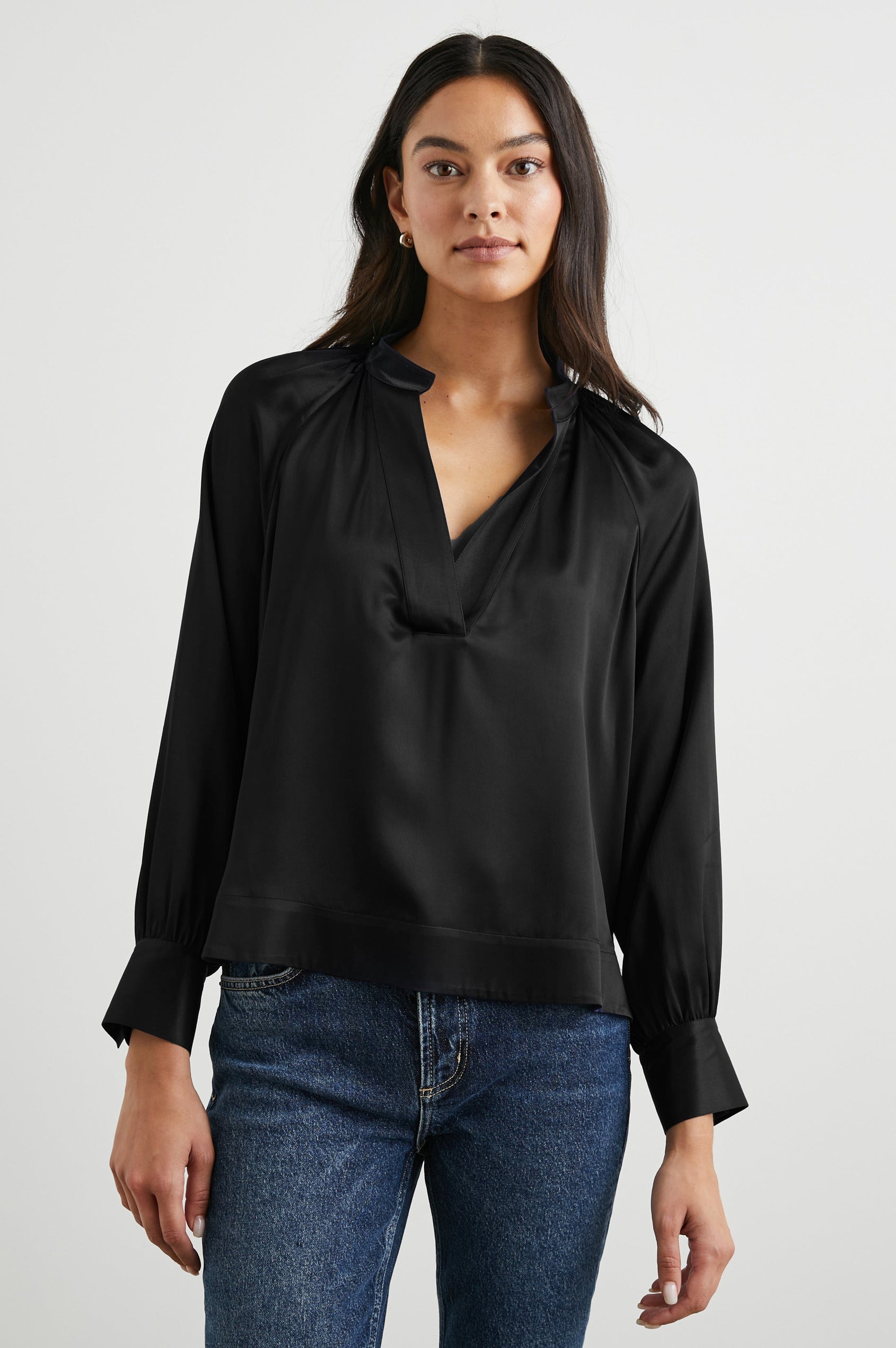 Wynna Long-Sleeve Top with a Deep V Neck and Ruching above the Cuffs and at the Neckline in Black Colorway - Front View Featured on Model