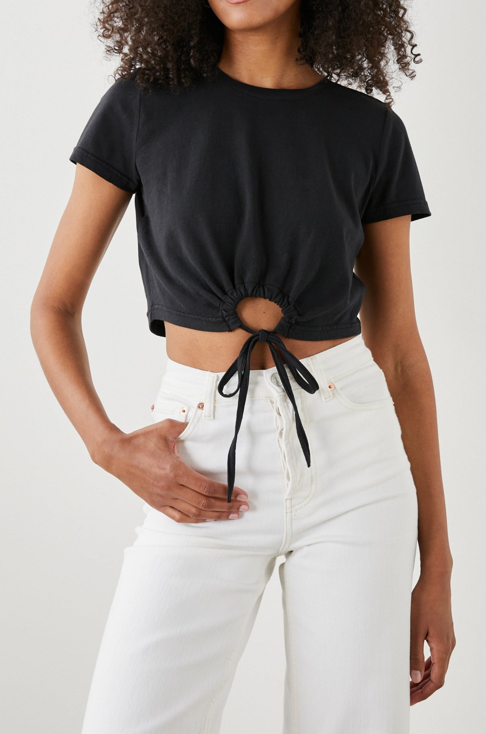 Zena Short-Sleeve Cropped T-Shirt with a Crew Neck and a Circular Cutout with a Tie at the Front Hem in Black Colorway - Front View Featured on Model