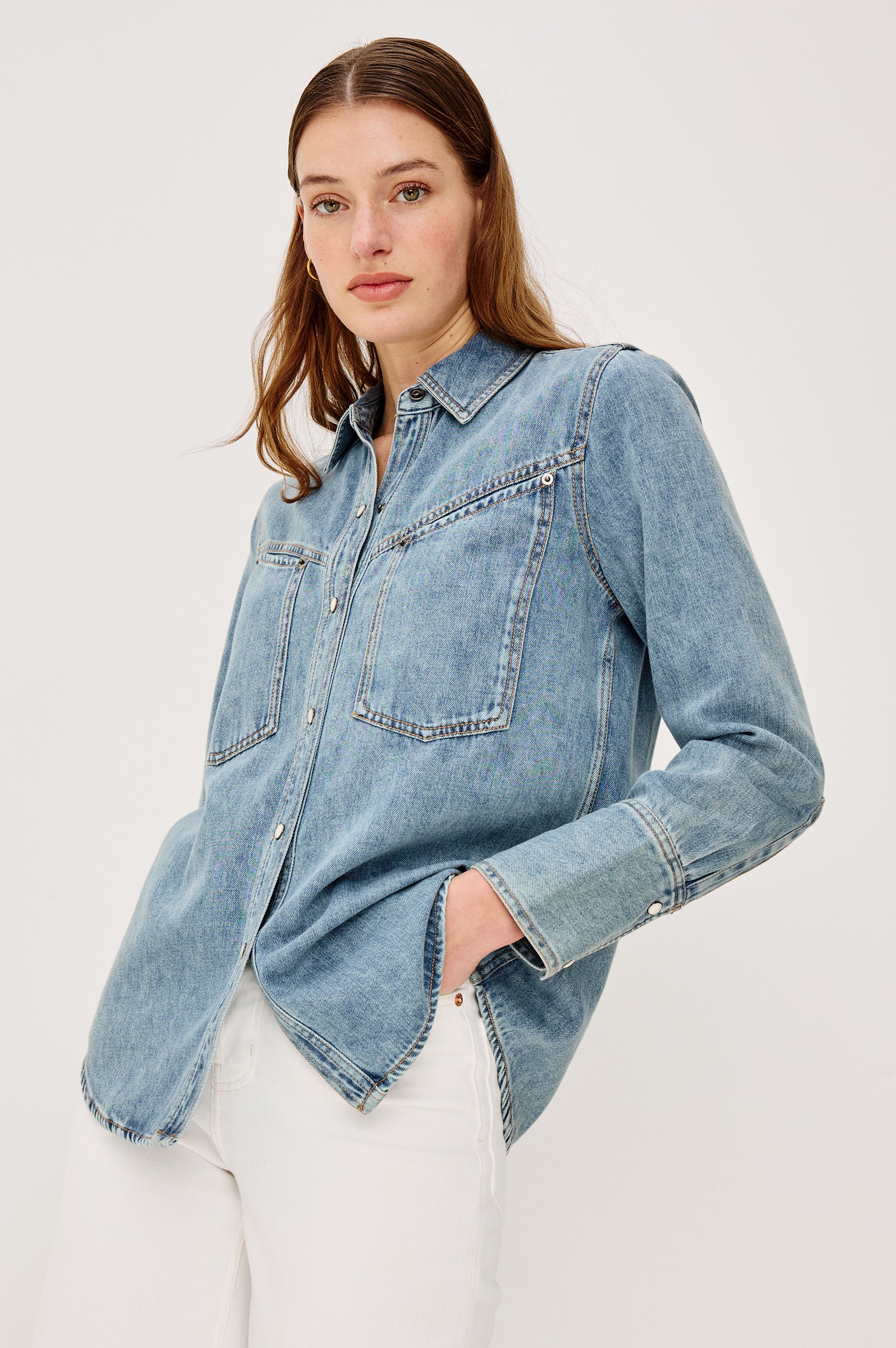 Acton Shirt in Cotton Lyocell Denim With Collar Front Snap Buttons Front and Back Yokes Gunmetal Snap Detailing and Long Sleeves in Wester Blue Colorway - Upper Body Front View Featured on Model