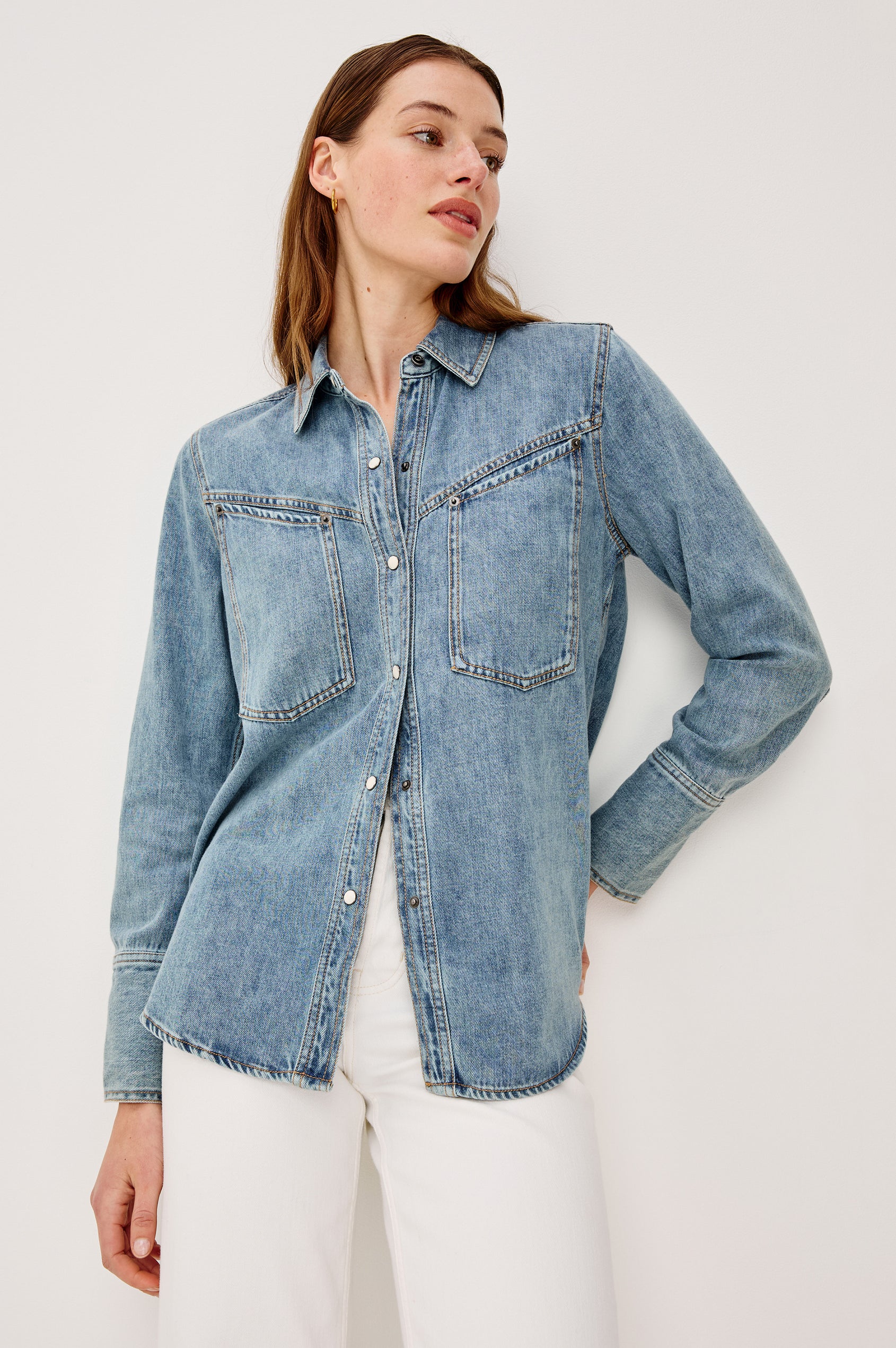 Acton Shirt in Cotton Lyocell Denim With Collar Front Snap Buttons Front and Back Yokes Gunmetal Snap Detailing and Long Sleeves in Wester Blue Colorway - Upper Body Front View Featured on Model