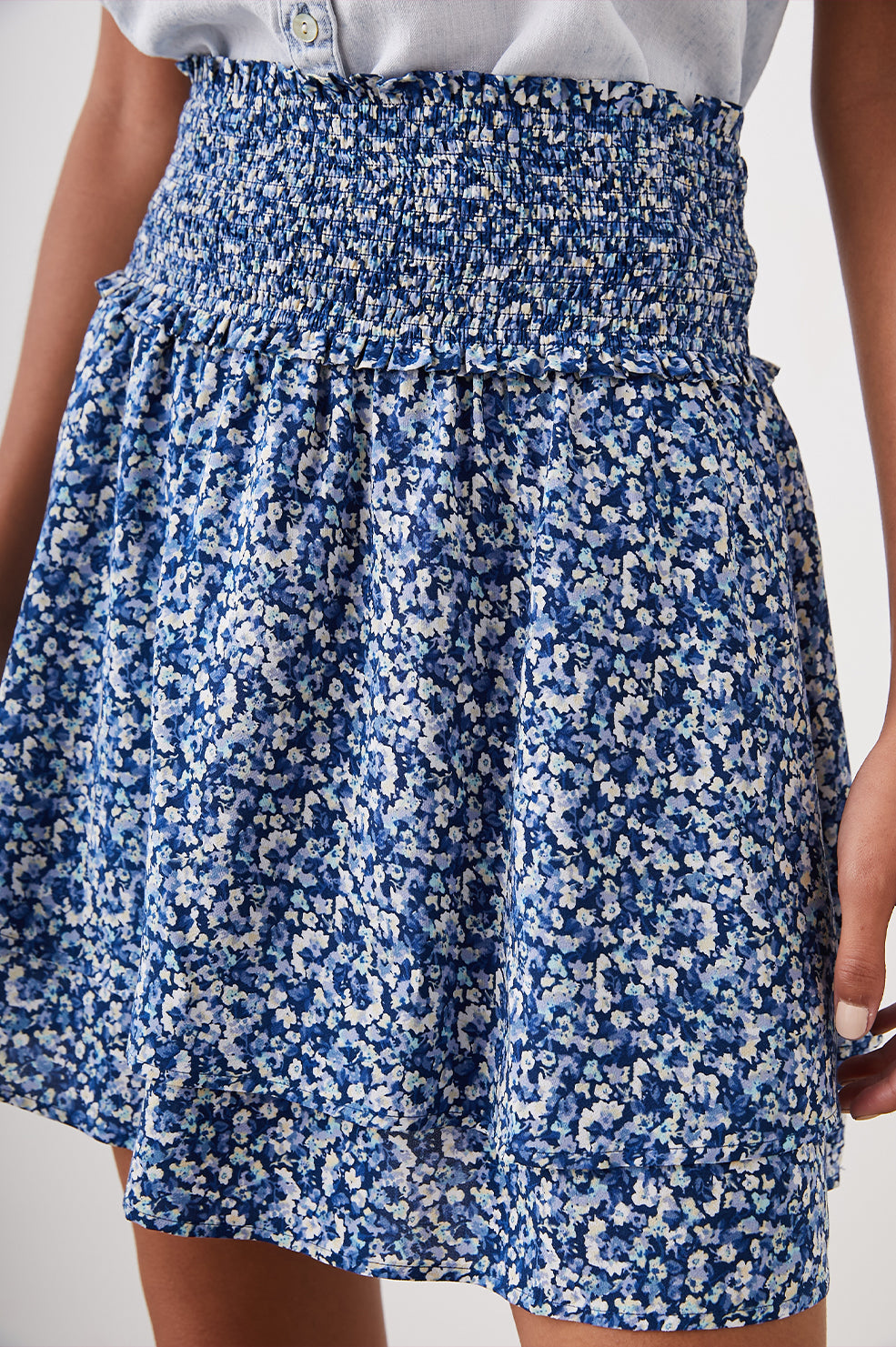 Addison Mini Skirt with a Smocked Waist and a Shorter Over Layer in Ice Chrysanthemum Colorway, Abstract Floral in White and Blues - Front View Featured on Model