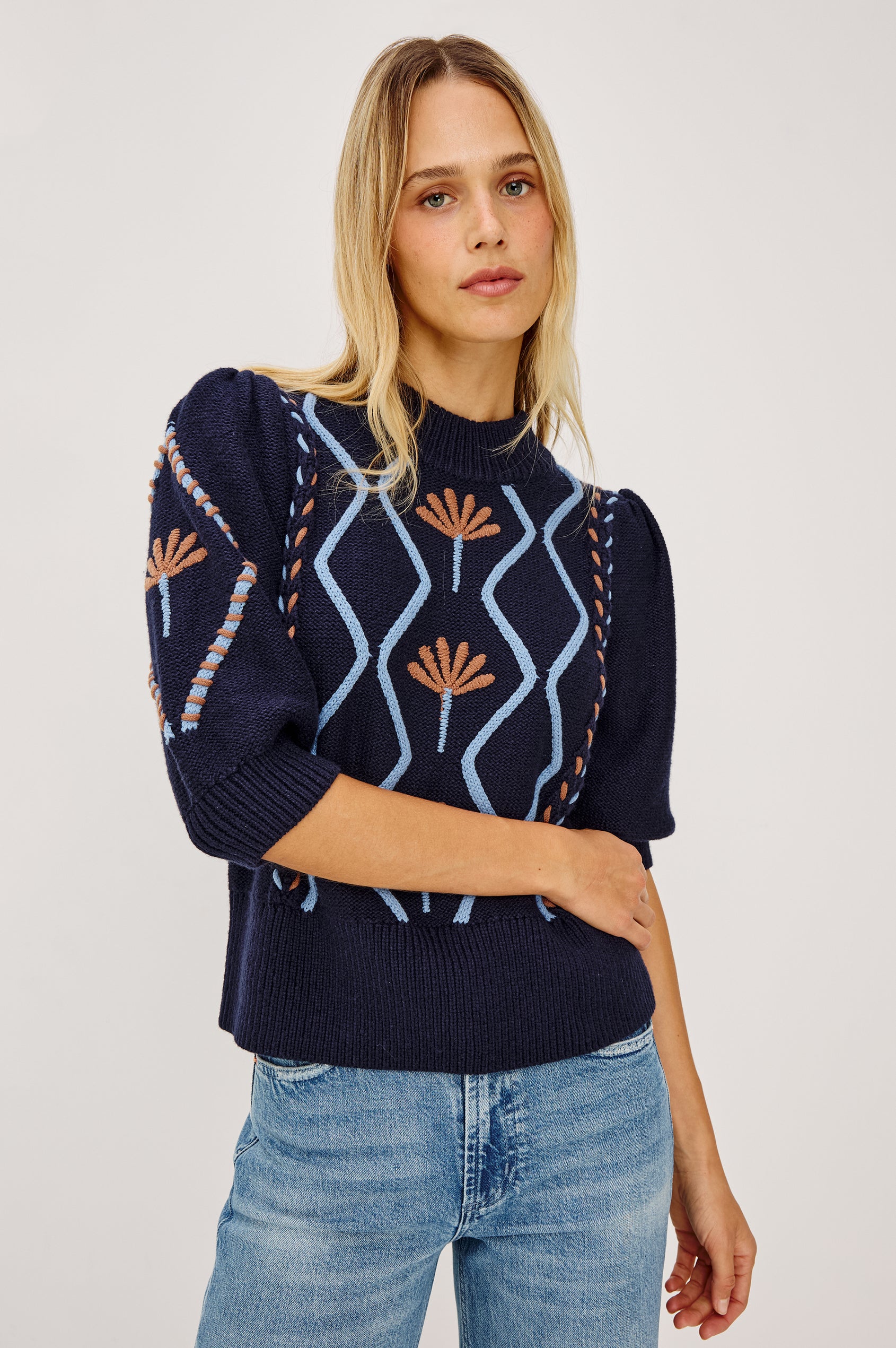 Addy Sweater in Cable Knit With Mock Neck, Relaxed Fit, and Elbow-Length Puff Sleeves in Floral Cables - Upper Body Front View Featured on Model