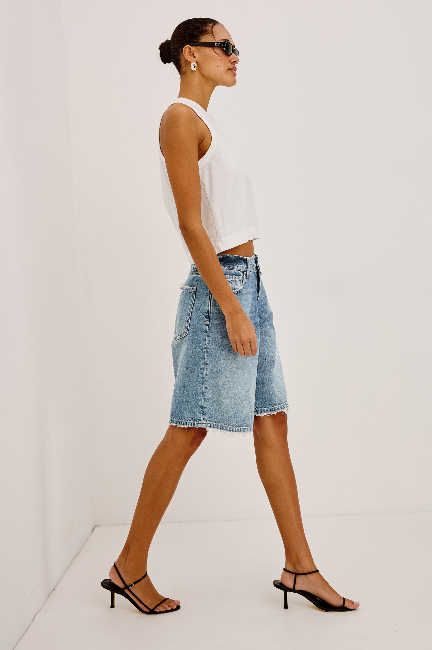 Agoura Short in Rigid Denim With Wide Leg, Relaxed, Low-Slung Fit, Distressed Detailing, Zip Fly, Belt Loops, and 5-Pockets in Authentic Stone Colorway - Lower Body Side View Featured on Model