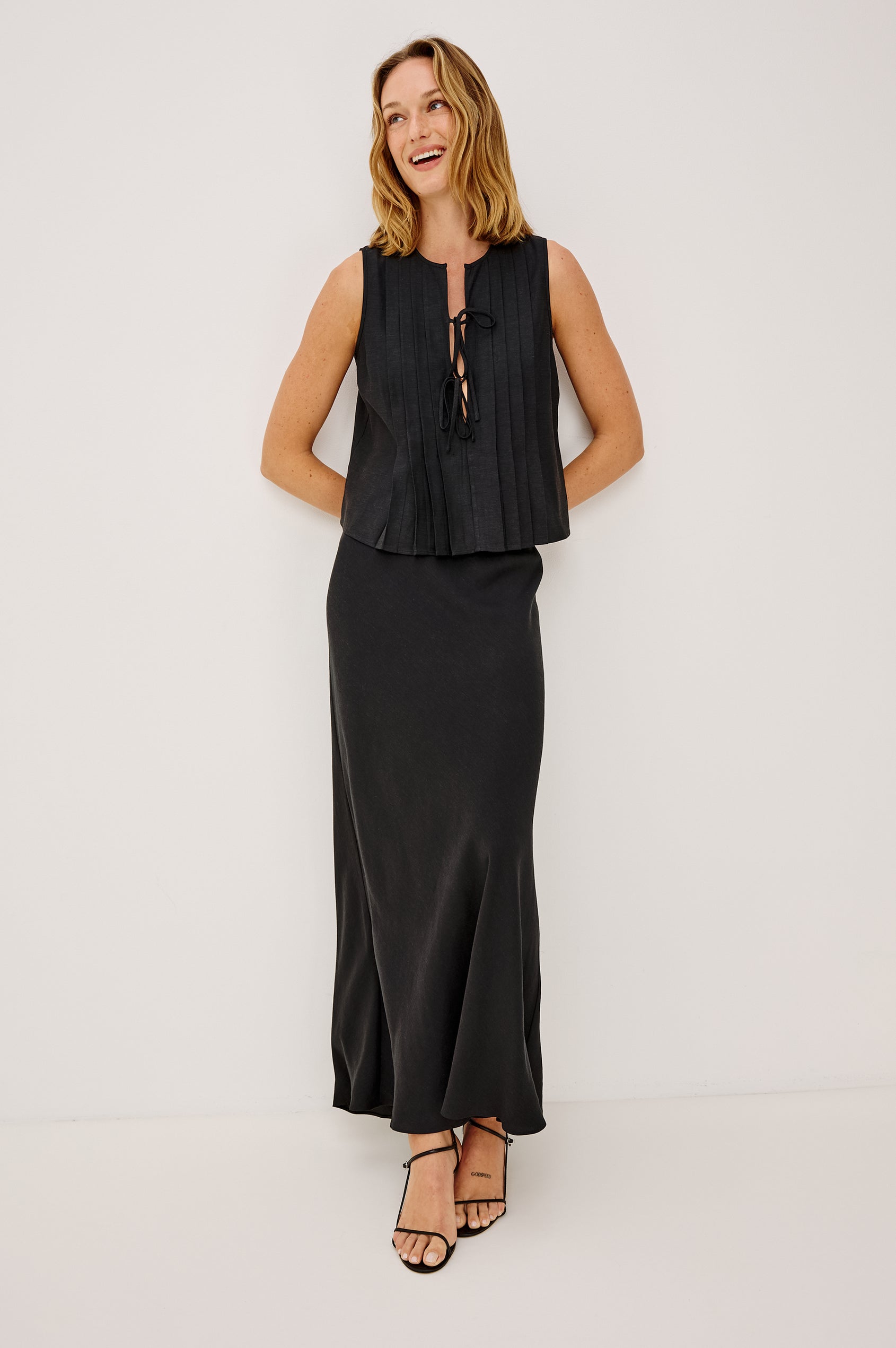 Aja Sleeveless Top in Linen With Plunging V-Neckline, Center-Front Ties, and Front Pleats in Black Linen Colorway - Full Body Front View Featured on Model