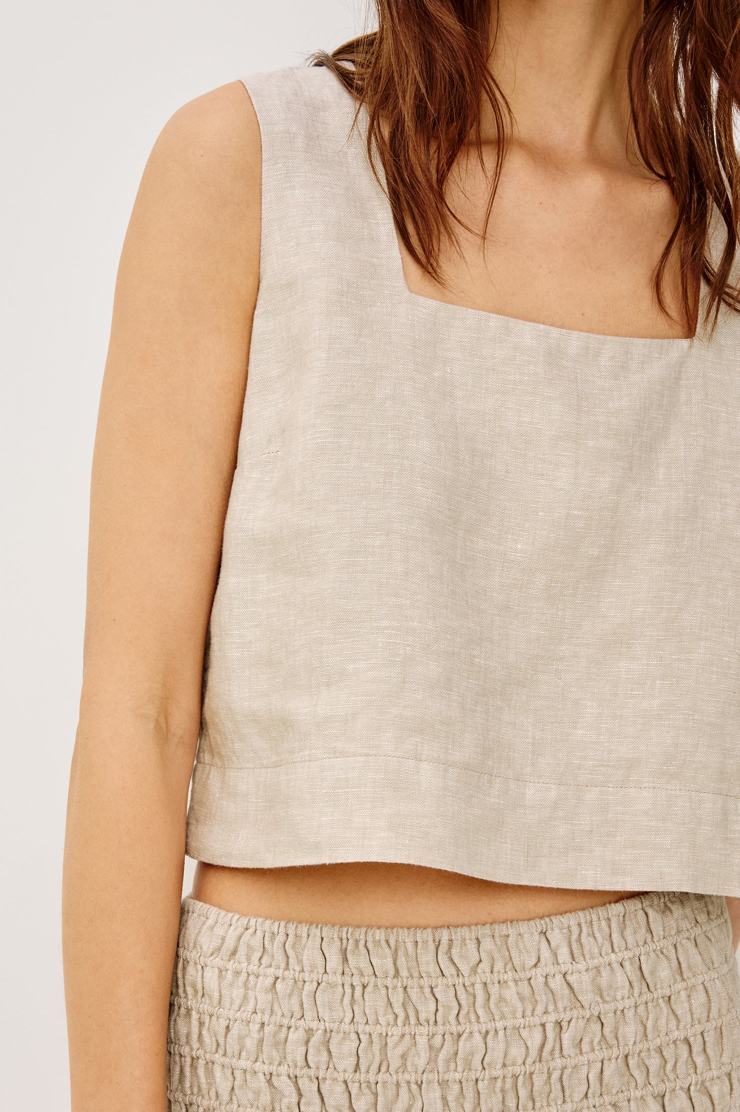 Akira Sleeveless Crop Top with Square Neckline and Wide Shoulder Straps in Heathered Flax Colorway - Front View Featured on Model