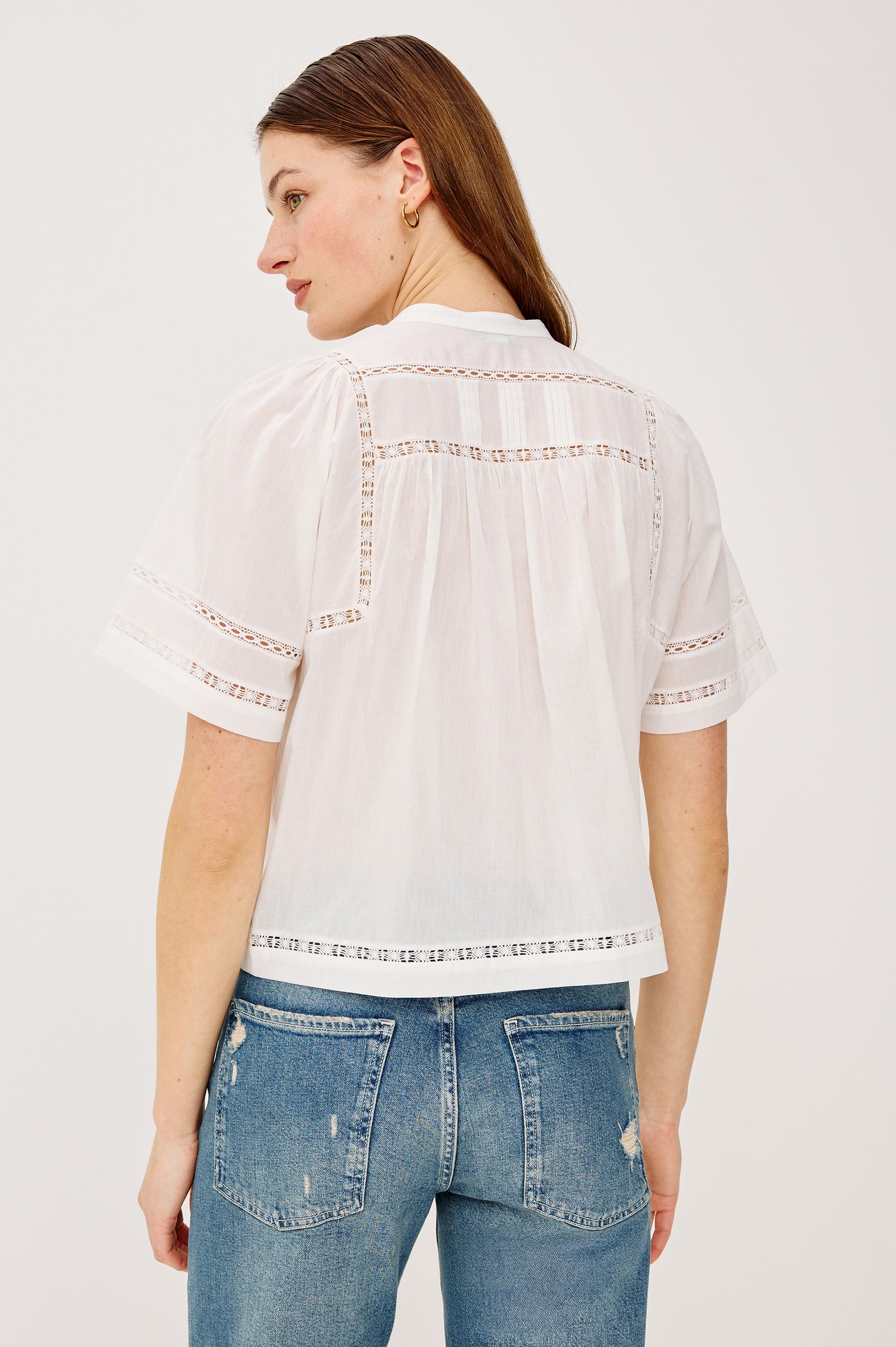 Alanis Shirt in Lightweight Cotton With Split Band V-Neckline, Front Button-and-Loop Closures, Lattice Embroidery, and Short Puff Sleeves in White Colorway - Upper Body Front View Featured on Model