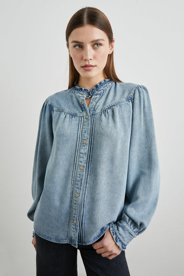 Alanna Long Sleeve Shirt with Snaps Down the Front, a Ruffled Collar, Banded Ruffed Cuffs, and Pleats at the Yoke Seam in Antique Indigo Colorway - Front View Featured on Model