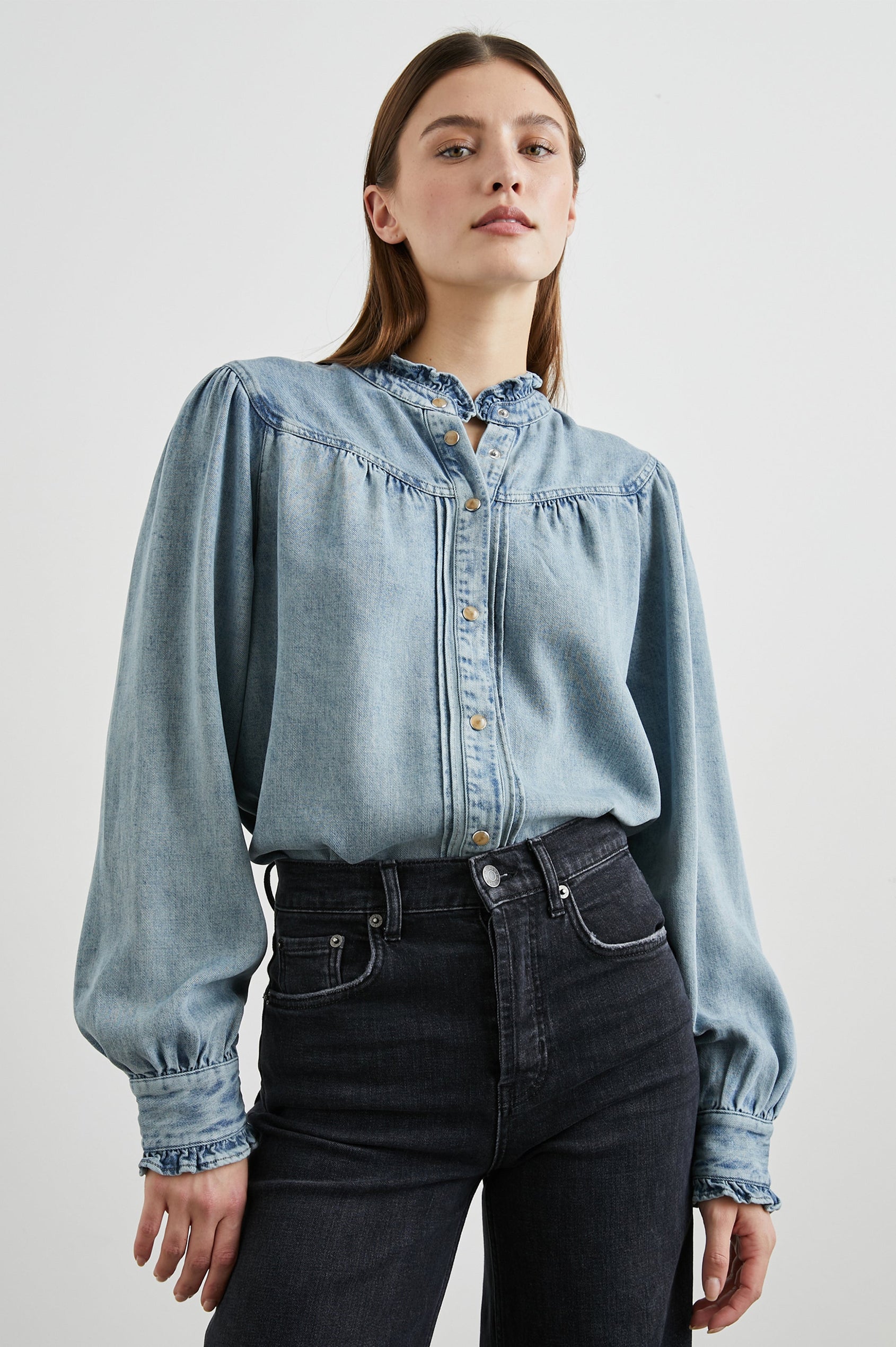 Alanna Long Sleeve Shirt with Snaps Down the Front, a Ruffled Collar, Banded Ruffed Cuffs, and Pleats at the Yoke Seam in Antique Indigo Colorway - Front Tucked View Featured on Model