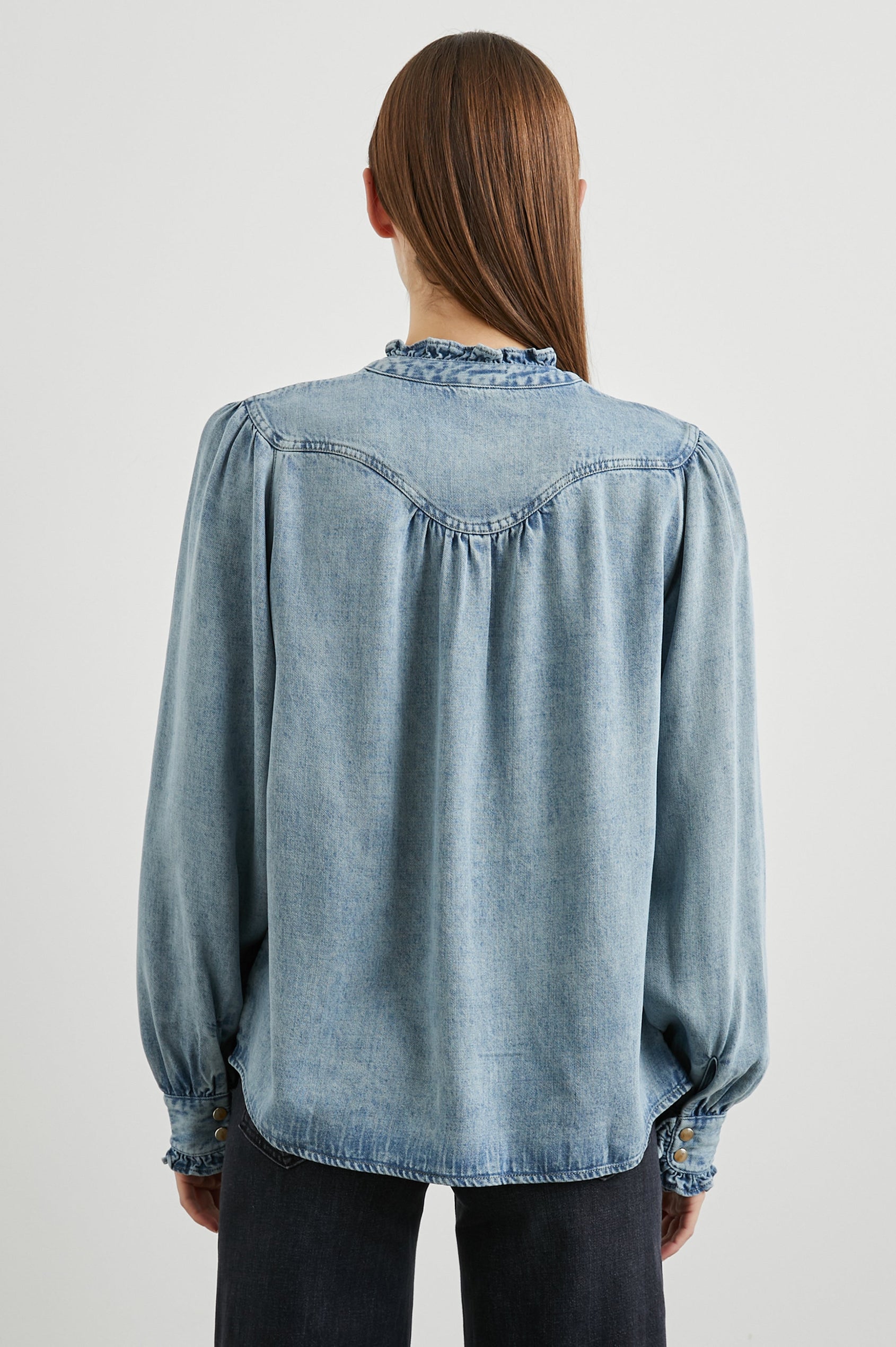 Alanna Long Sleeve Shirt with Snaps Down the Front, a Ruffled Collar, Banded Ruffed Cuffs, and Pleats at the Yoke Seam in Antique Indigo Colorway - Back View Featured on Model