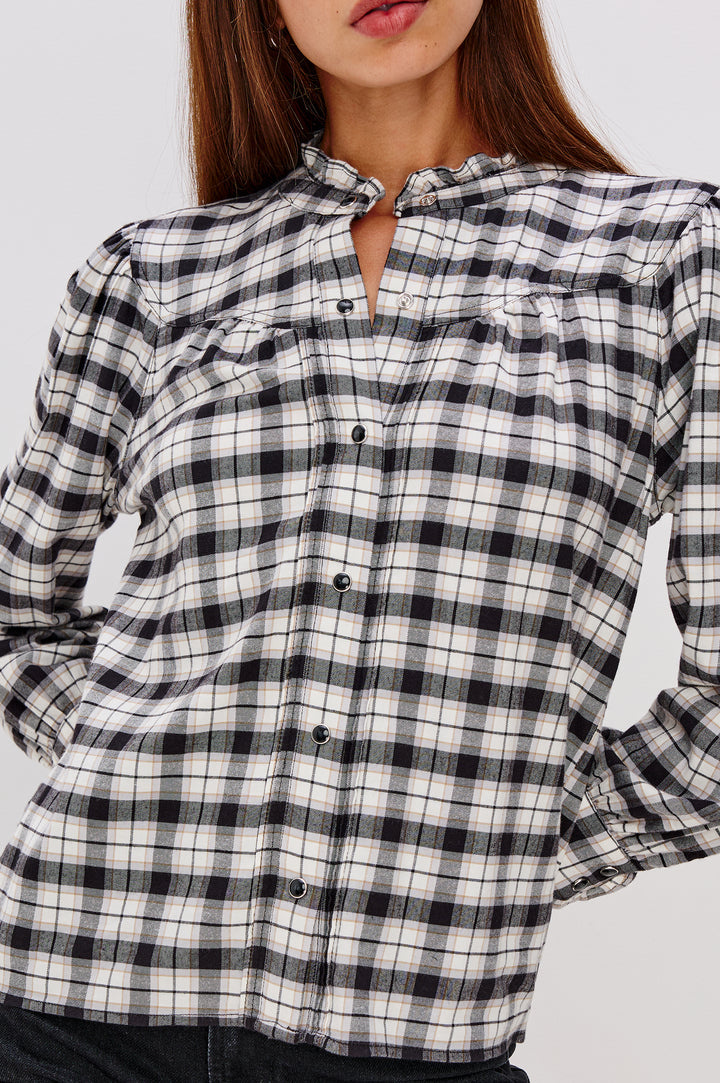 Alanna Long Sleeve Shirt with Snaps Down the Front, a Ruffled Collar, Banded Ruffed Cuffs, and Pleats at the Yoke Seam in Ivory Smoke Onyx Colorway - Close Up Untucked View Featured on Model